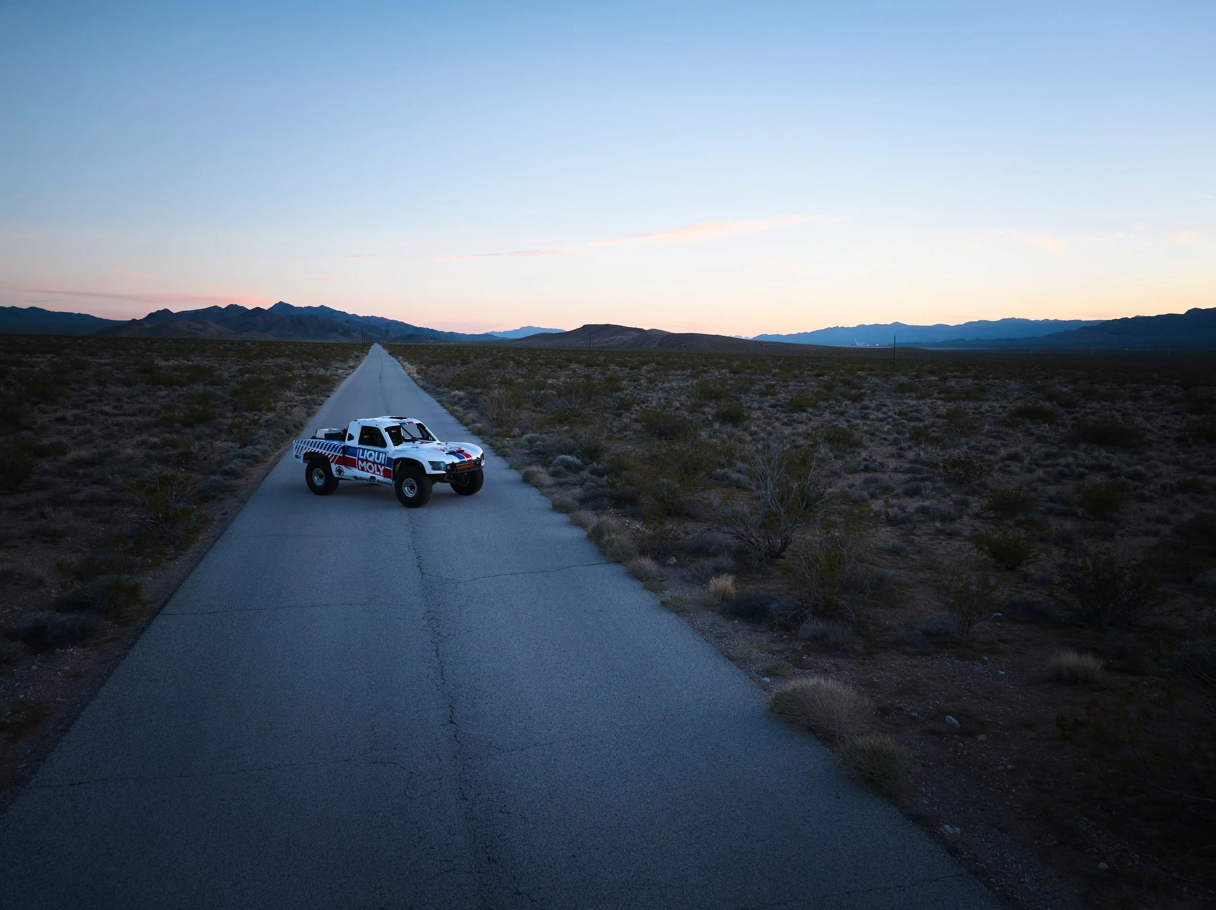 Professional photography shoot capturing vehicle in desert landscape in Arizona
