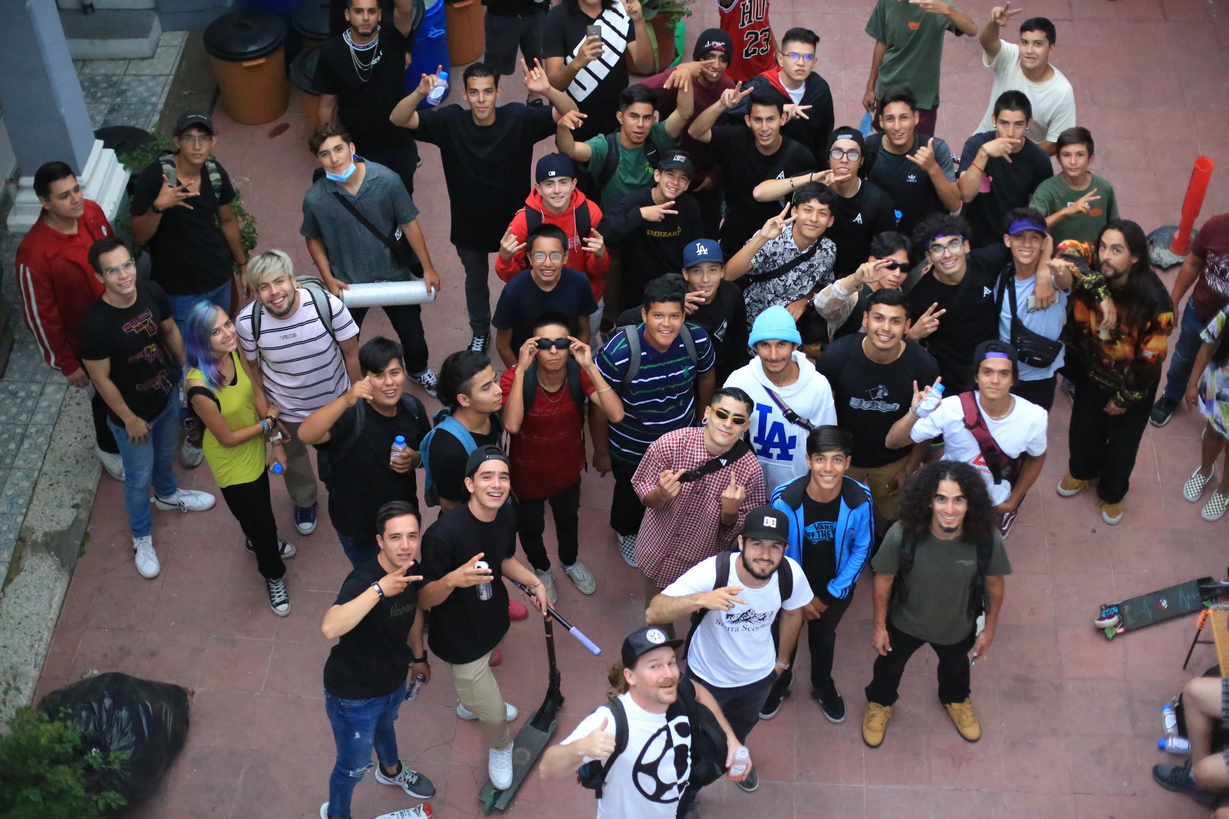 Documentary footage of Mexican scooter riders gathering to watch final videos from a week-long filming event in Guadalajara