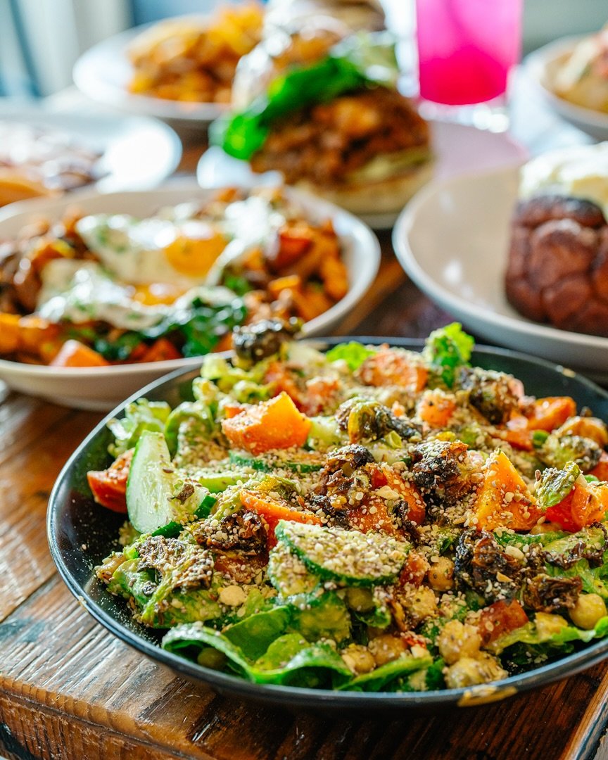 Our Harvest Salad is packed with seasonal goodness: local greens from @kalerafarms, tomatoes and cucumbers from @rockymountainfreshco, roasted veggies, chickpeas, pepitas, and a sprinkle of furikake, all tossed in a creamy cashew green goddess dressi