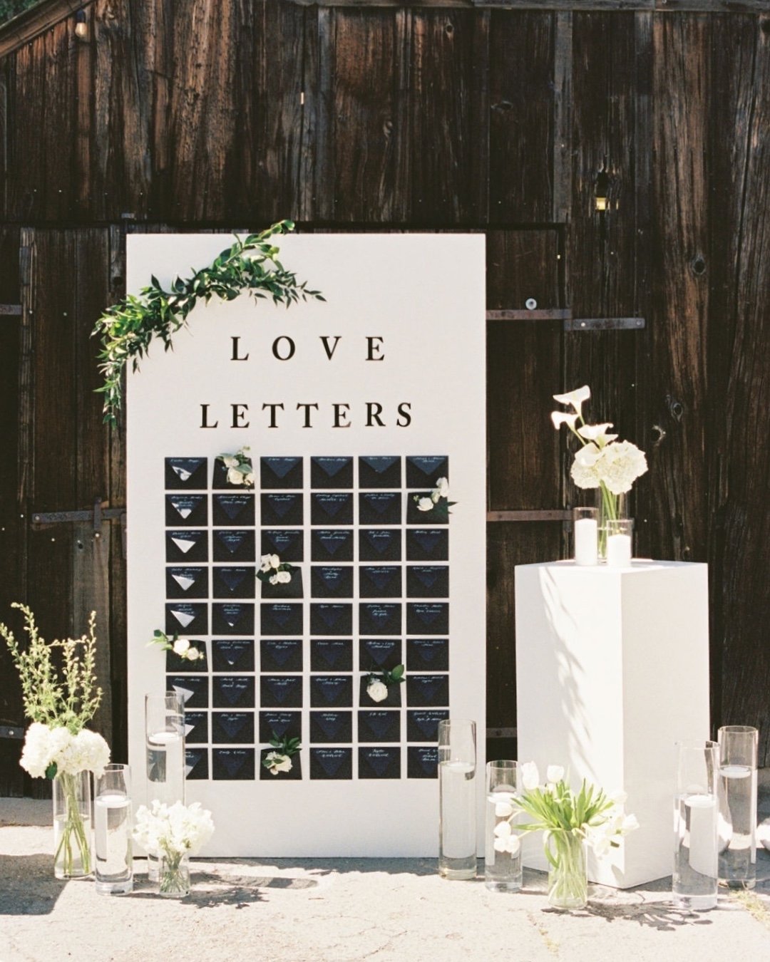 Each guest found their seat by finding an envelope with their name on it, handwritten in calligraphy and filled with a little love letter waiting inside. Simple, thoughtful, and something guests could take home with them. I love when seating charts d