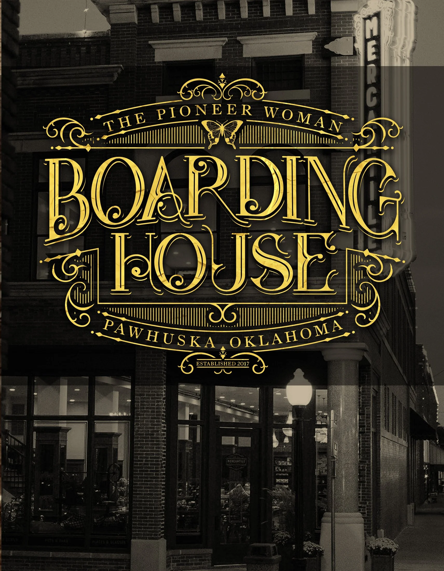 Sign for 'The Pioneer Woman Boarding House' in Pawhuska, Oklahoma, with decorative gold lettering and a butterfly graphic.
