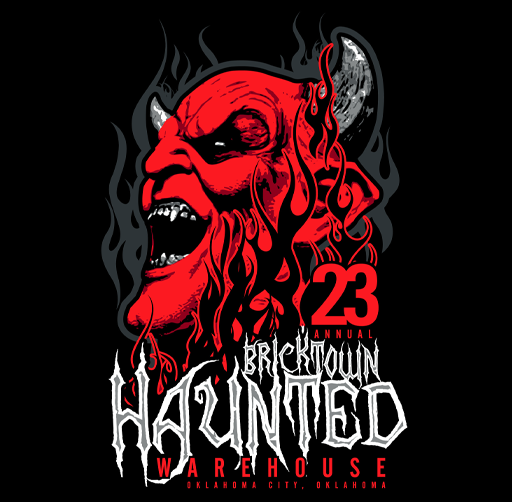 A graphic illustration of a red devilish face with horns, sharp teeth, and an angry expression, surrounded by black flames, promoting the 23rd annual Bricktown Haunted Warehouse event in Oklahoma City, Oklahoma.