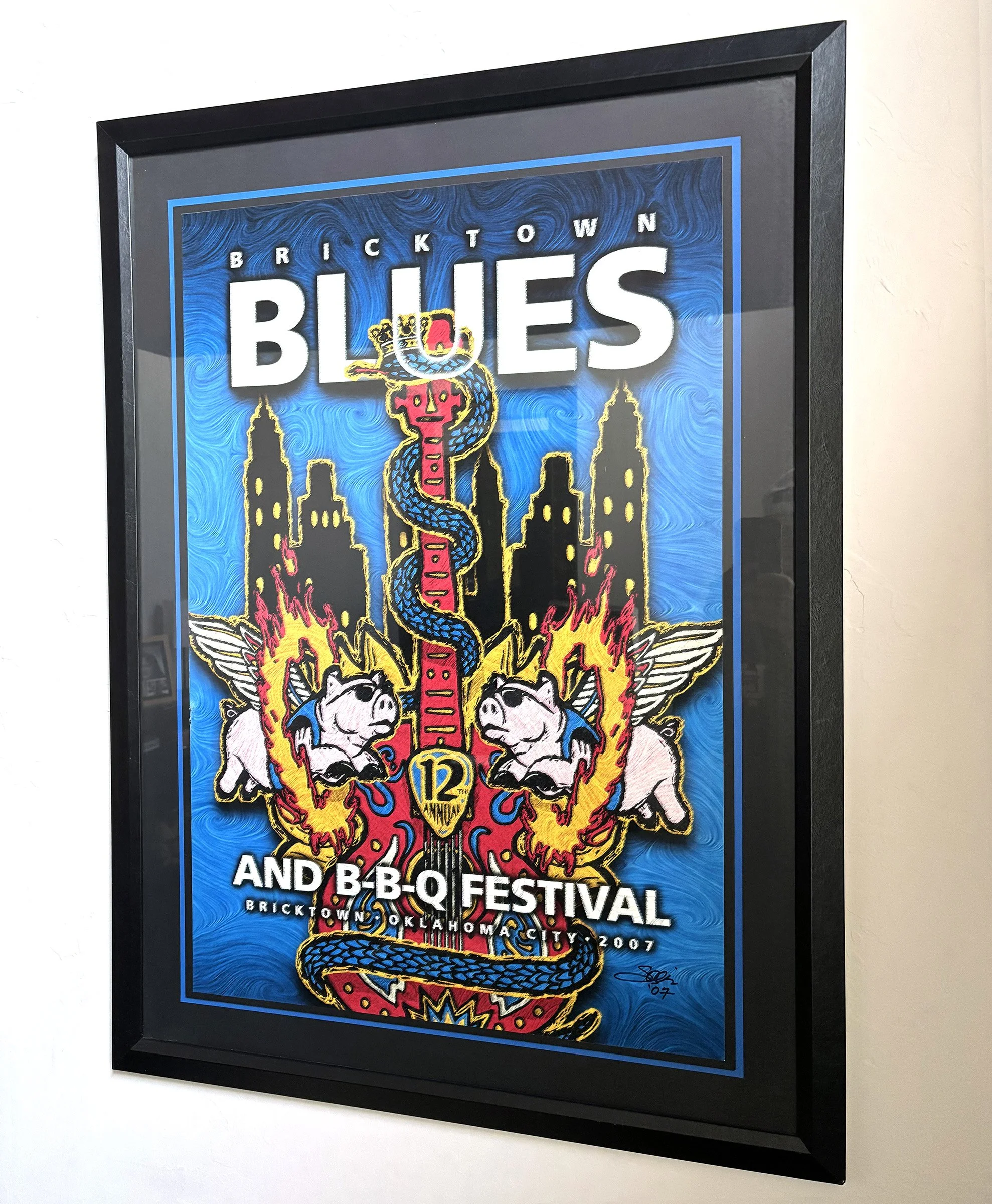 Poster promoting Bricktown Blues and BBQ Festival in Oklahoma City, 2007, featuring a colorful design with a snake, skulls, flames, and text.