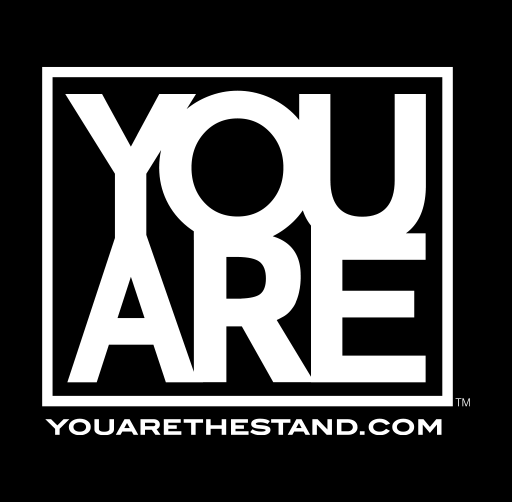 "YOU ARE", bold white text on black background reading "YOU ARE" with a border and the website "YOUARETHESTAND.COM" at the bottom.