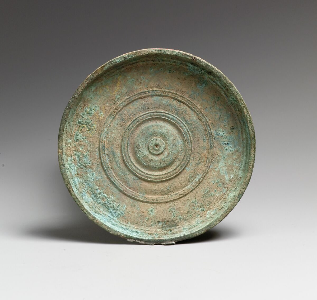 Mirror, Ancient Greece, Late Classical or Hellenistic, 4th-3rd century B.C., Bronze, 12.4 cm diameter. Metropolitan Museum of Art, New York, U.S.A. (96.9.372)