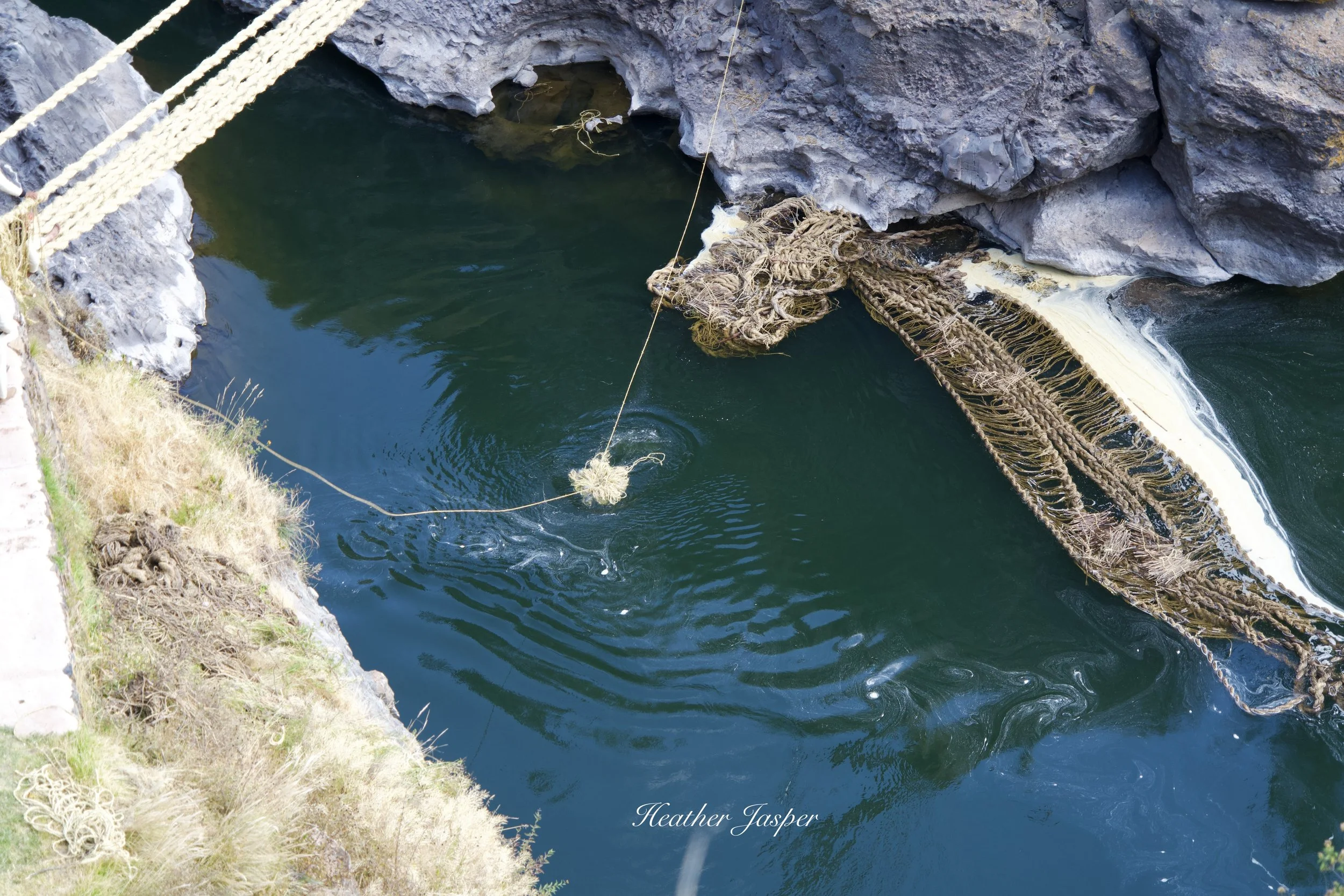 Newly twisted ropes are soaked to make them easier to work with. The old bridge is left to decompose in the river. 