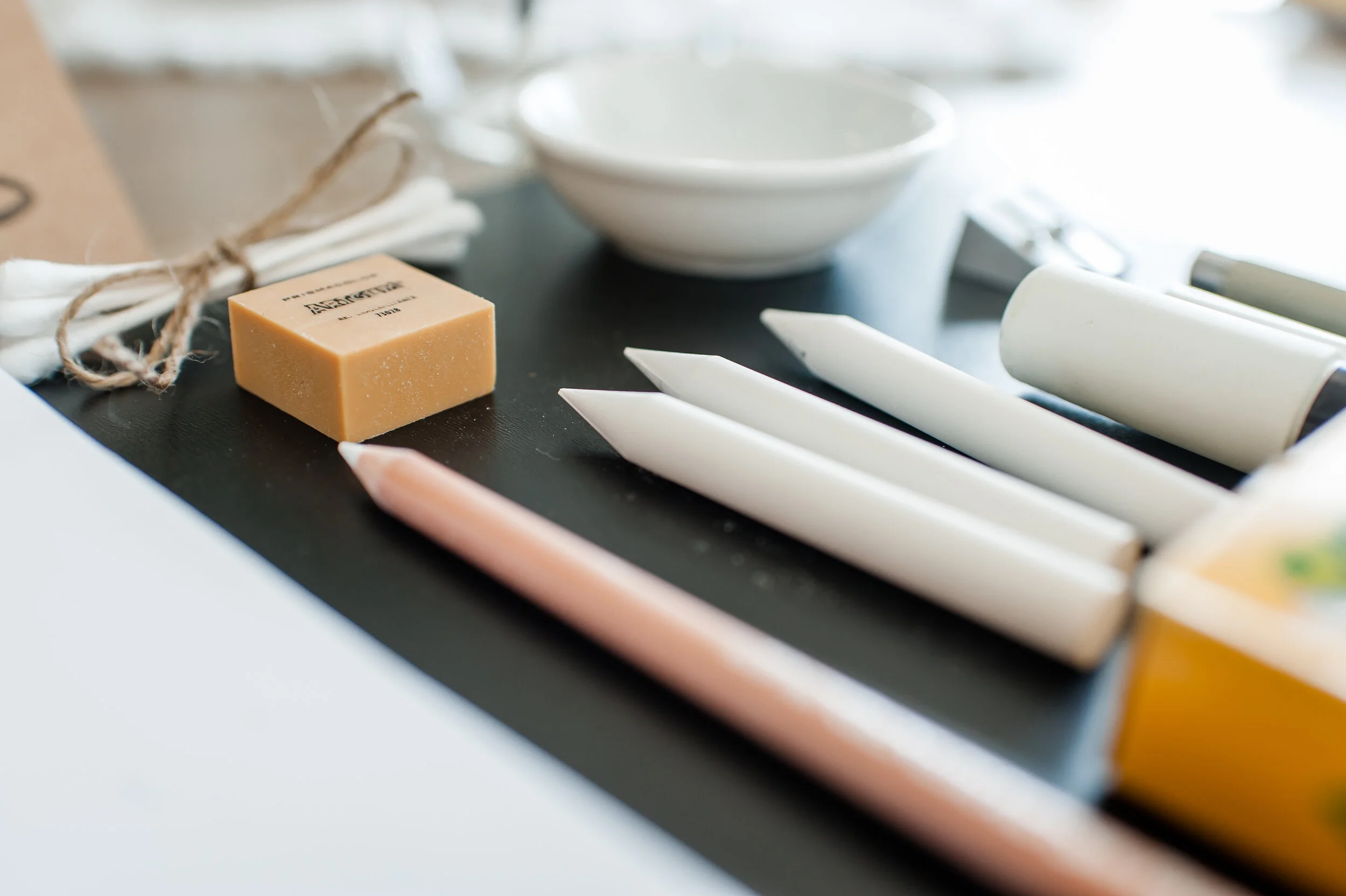 Various soap bars and a small bowl on a black tray.