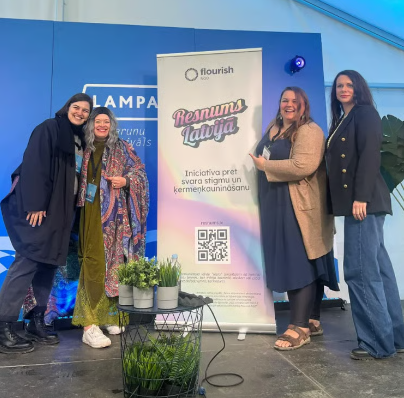 [Caption: Ieva and other speakers at the first public event produced by Flourish NGO. Photo credit: Flourish NGO]