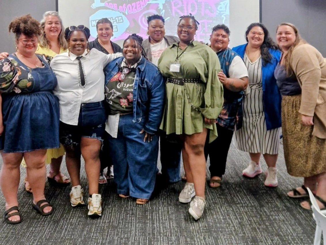 [Accessibility description: A photo of ten people standing and facing the camera.]