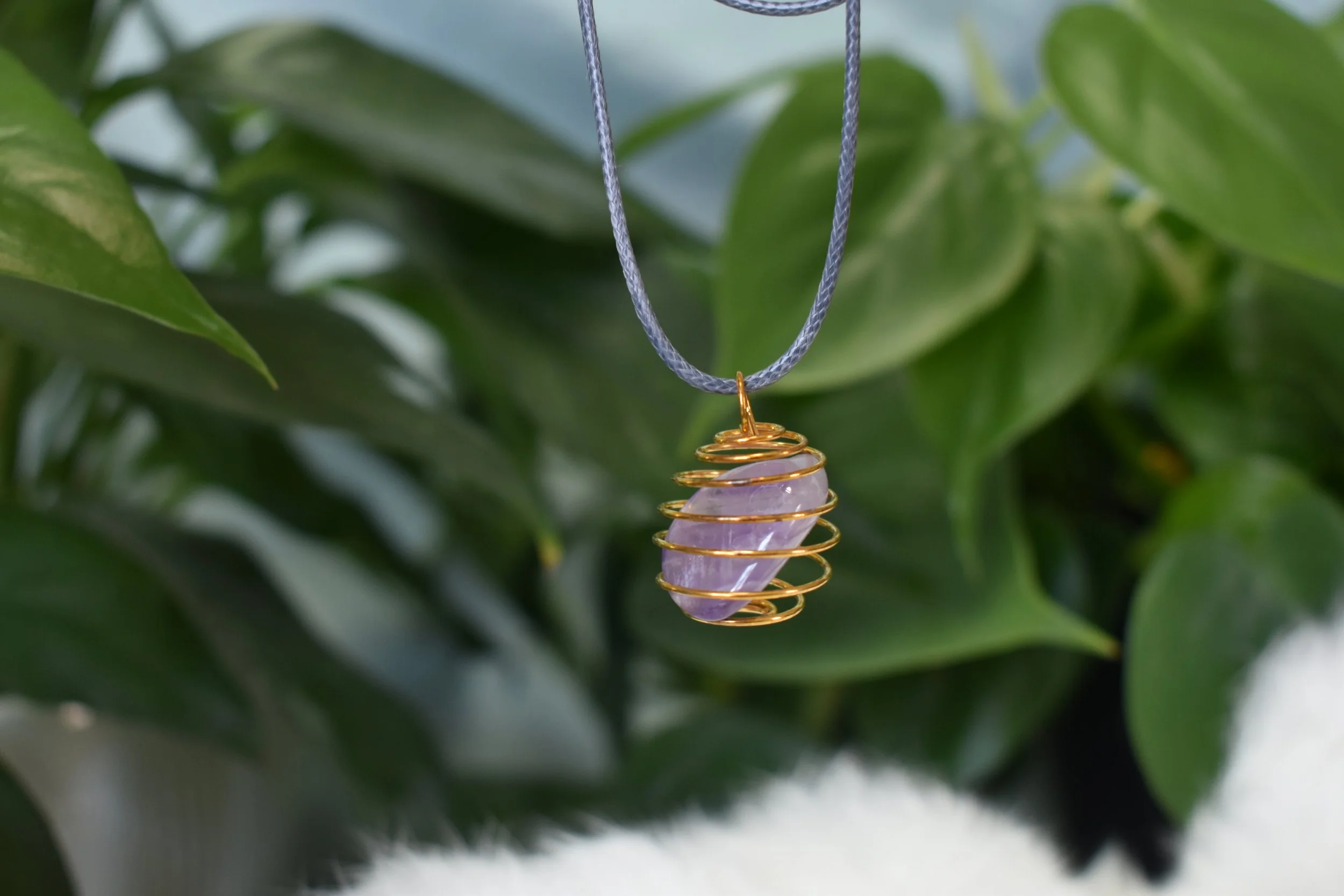 Amethyst tumble in a cage