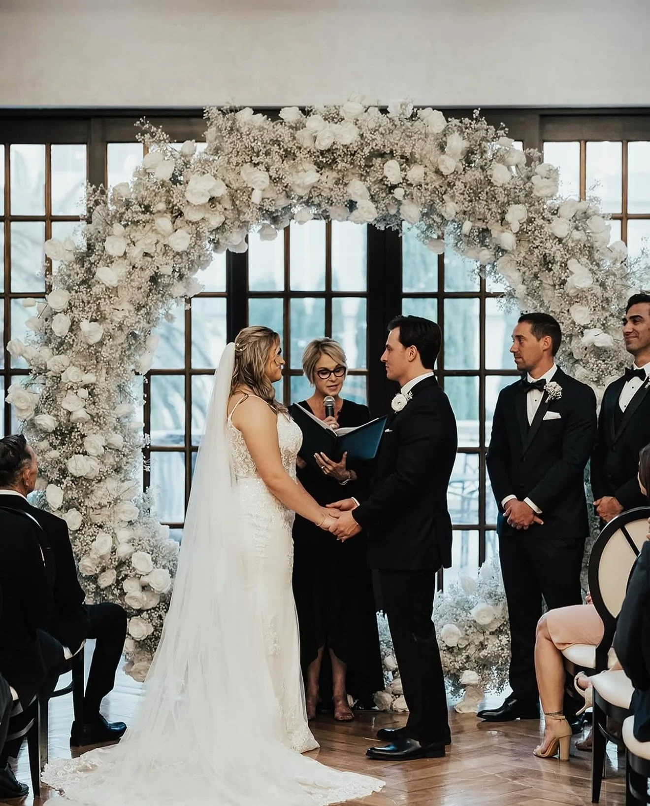 Our 9ft luxury flower arches are handmade with love. A breathtaking and ethereal flower arch. White roses and baby’s breath make our You’re The One flower arch a show stopper! 🤍 Perfect for wedding ceremonies, behind sweetheart tables, o
