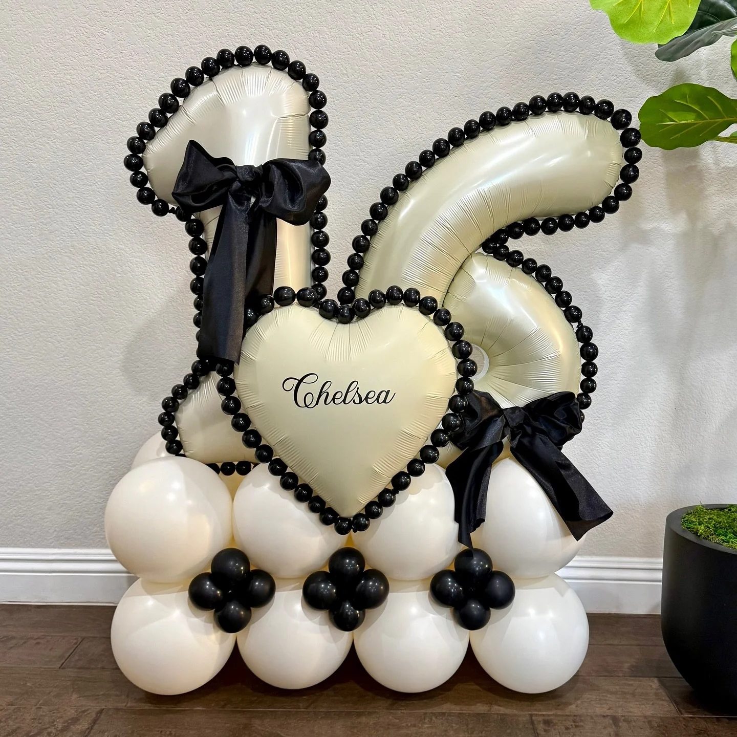 Balloon towers make the perfect gift or party decor! Our Coco Balloon Tower is adorned with balloon pearls, two large satin bows, and optional name decal. 🖤 Custom colors and special requests are welcomed. Designer Flower Walls #flowerwallslasvegas