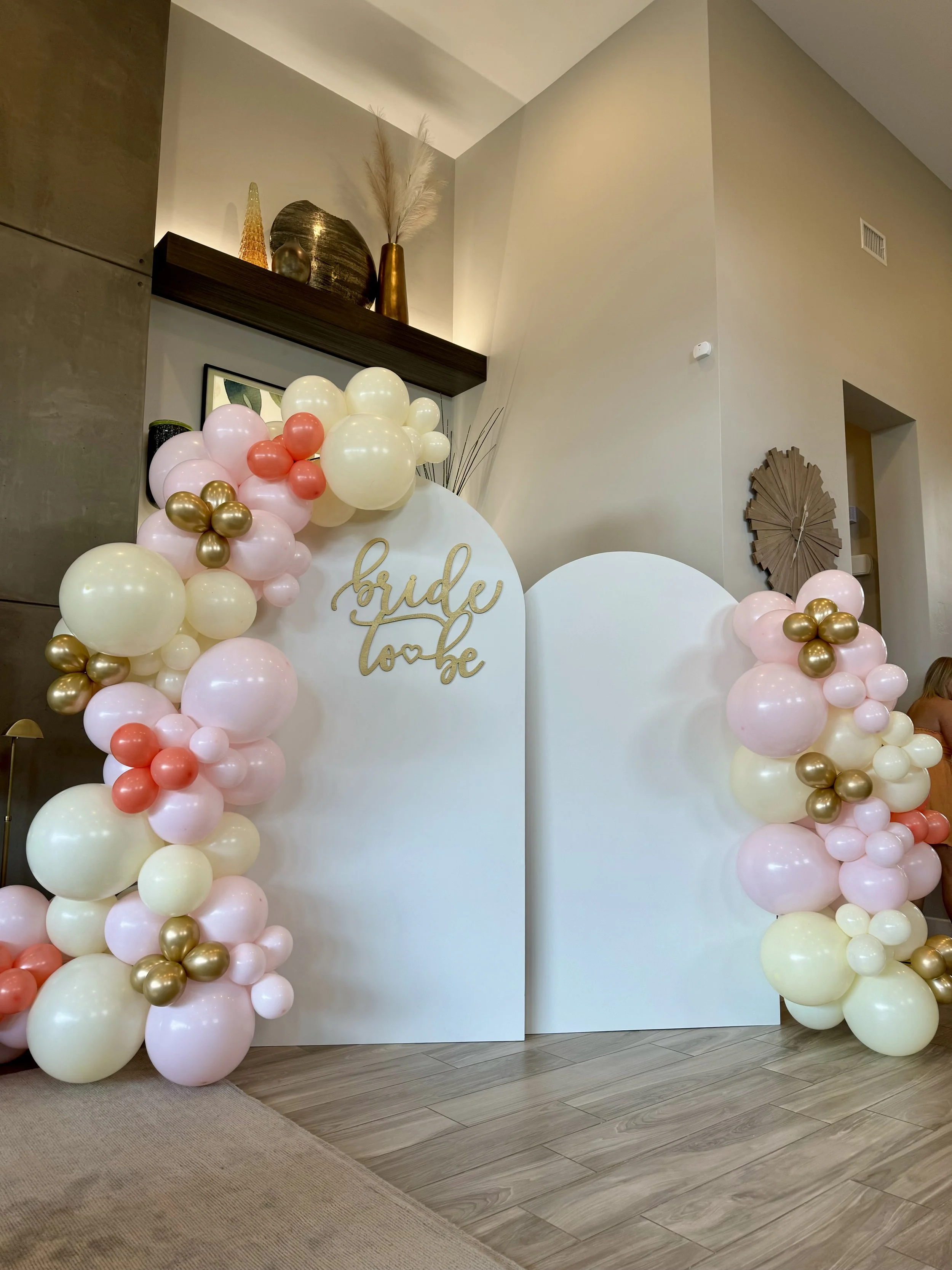 chiara wooden arched wall with wooden sign and balloon garland flower walls Las Vegas
