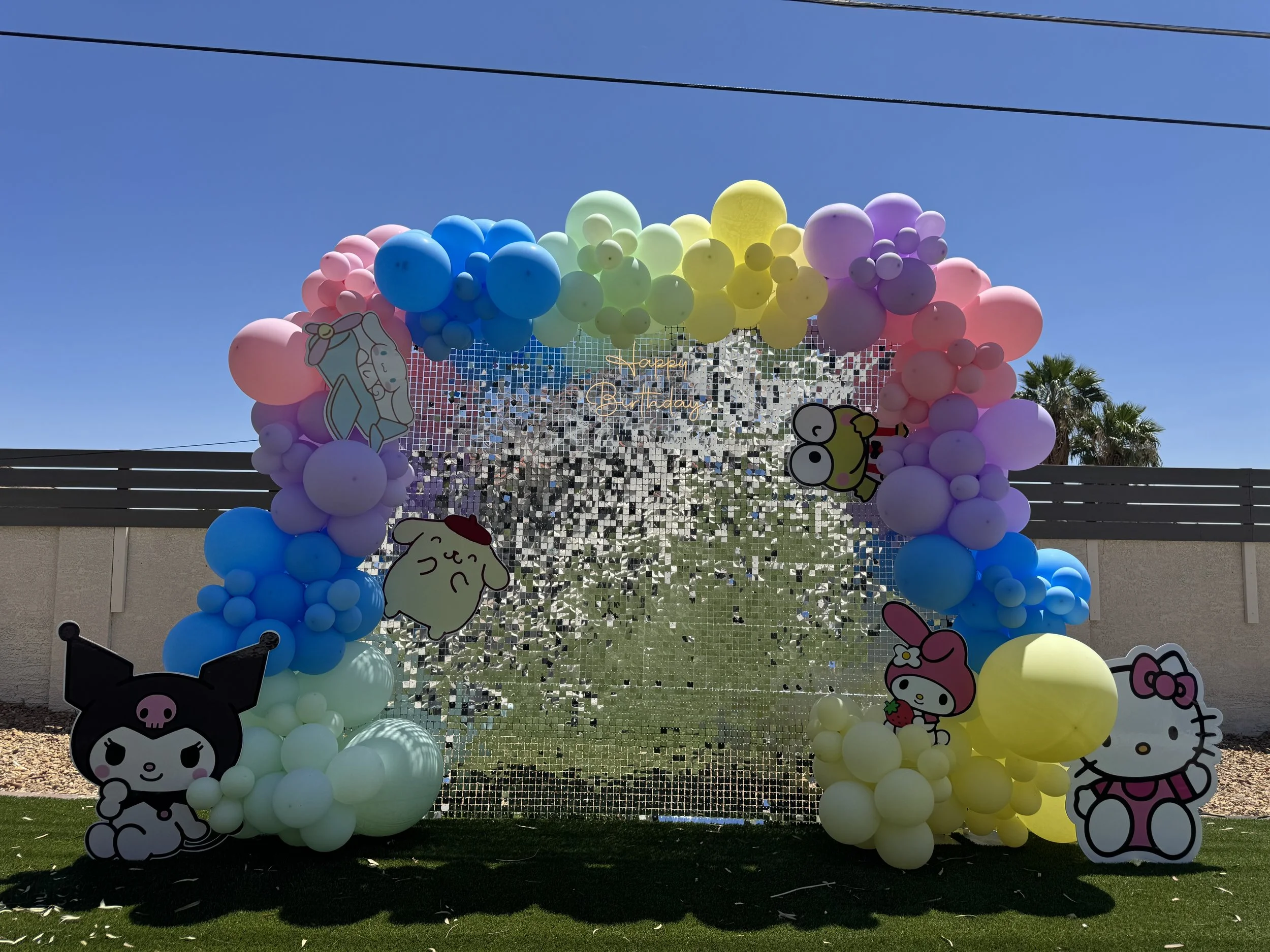 shimmer wall with Sanrio character cut outs and balloon garland