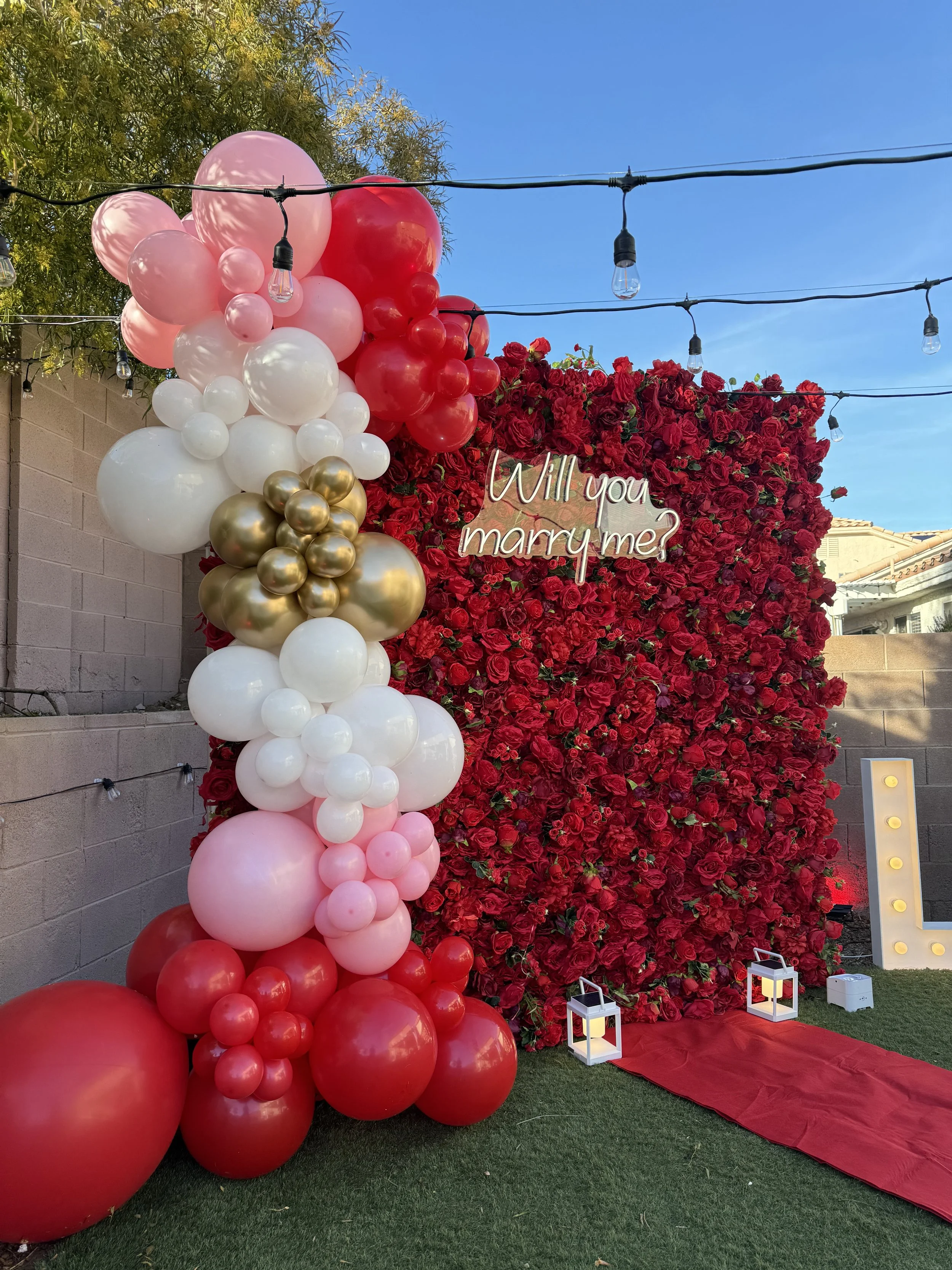 proposal red flower wall and balloon garland