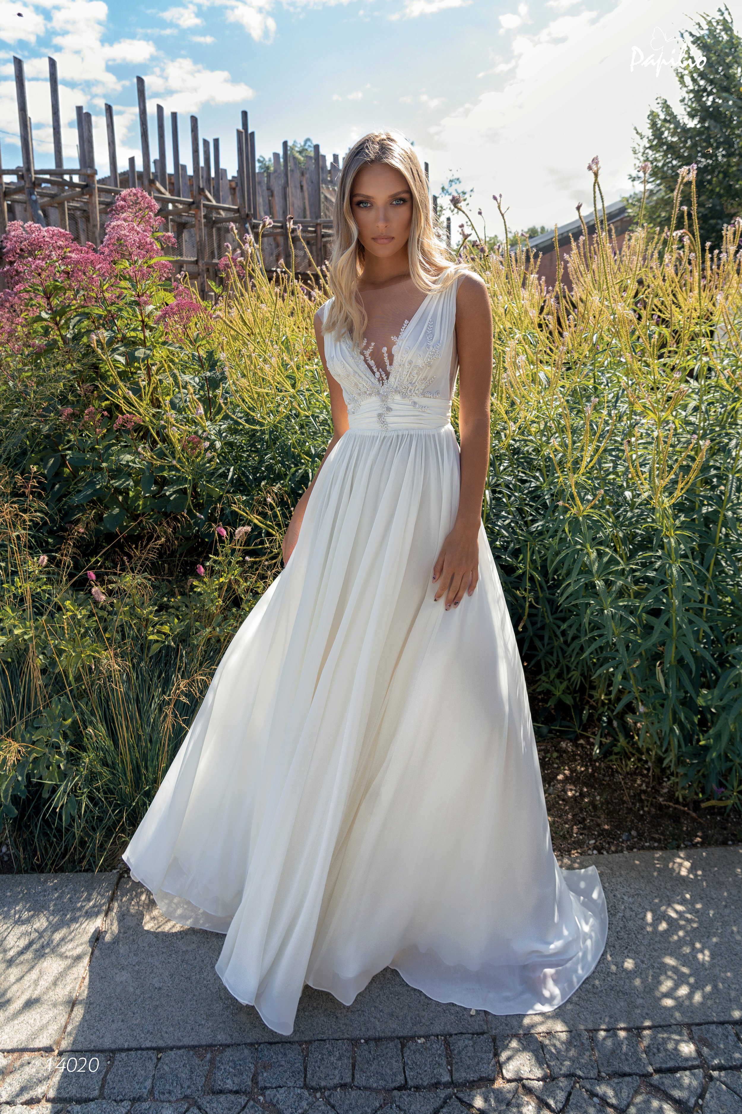 Off-shoulder wedding dress with a removeable cape is made of 