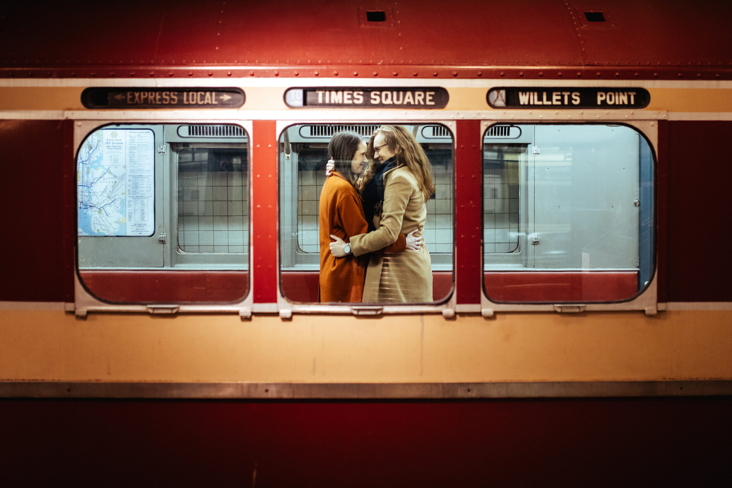 LGBTQ couple holding each other on a historic New York City subway car Shawnee Custalow Queer Wedding Photographer