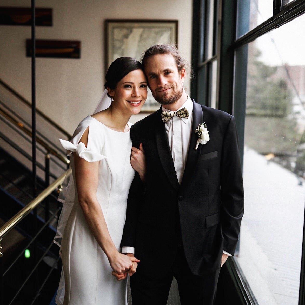 Bride and groom holding hands on a stairwell in Richmond VA Shawnee Custalow Queer Wedding Photographer