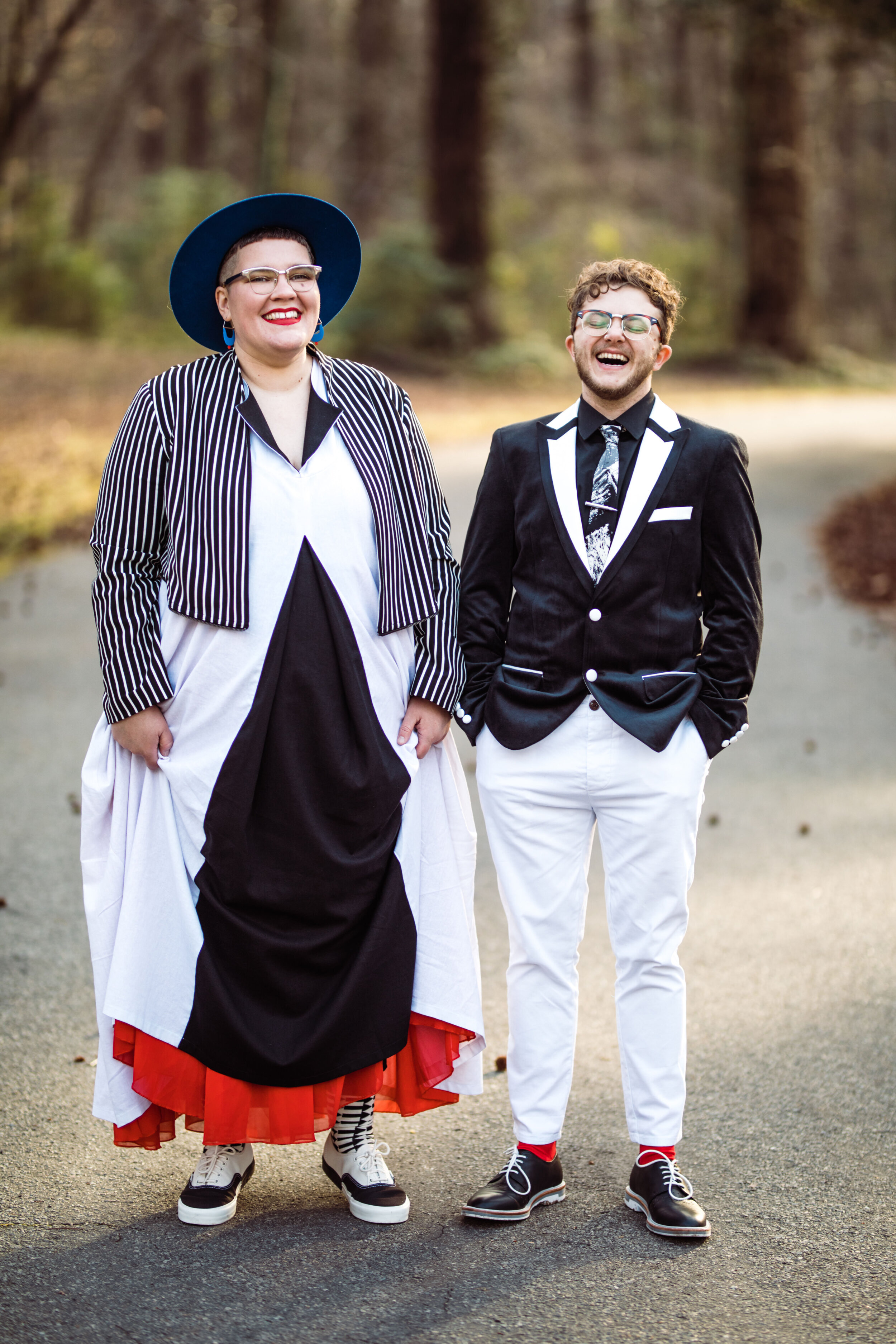 LGBTQ couple smiling and laughing in unique black and white wedding attire RVA Shawnee Custalow Queer Wedding Photographer