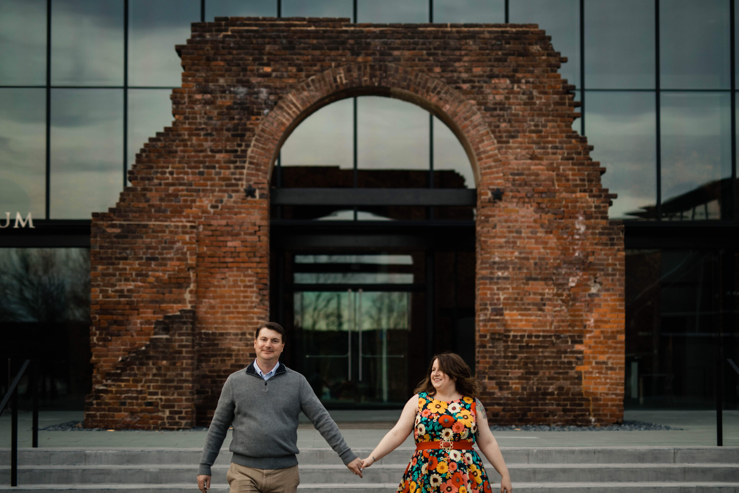 Engaged couple holding hands at the American Civil War Museum in RVA Shawnee Custalow Queer Wedding Photographer