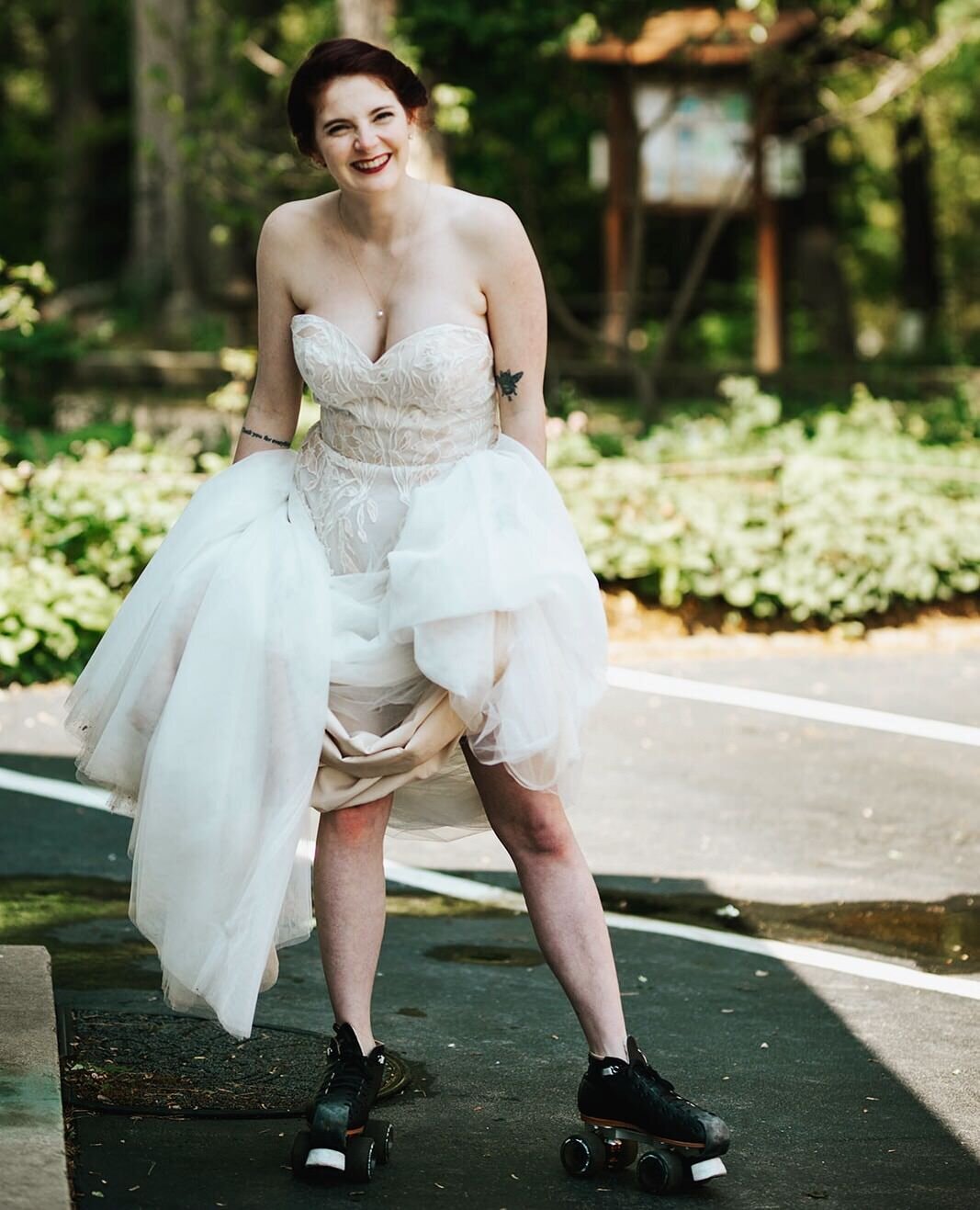Bride holding up her wedding dress wearing roller blades in Richmond VA Shawnee Custalow Queer Wedding Photographer