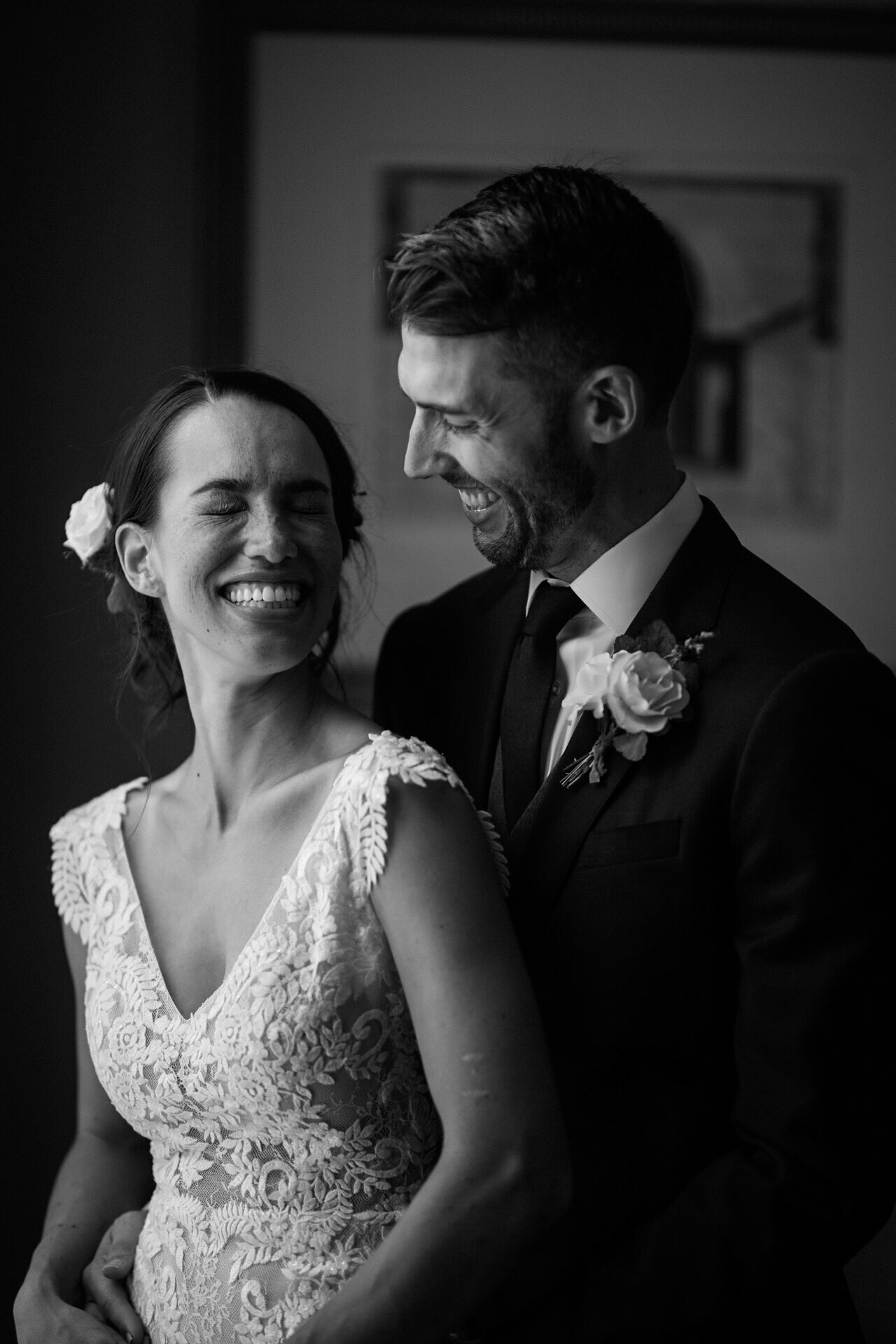 Bride and groom laughing together in black and white RVA Shawnee Custalow Queer Wedding Photographer