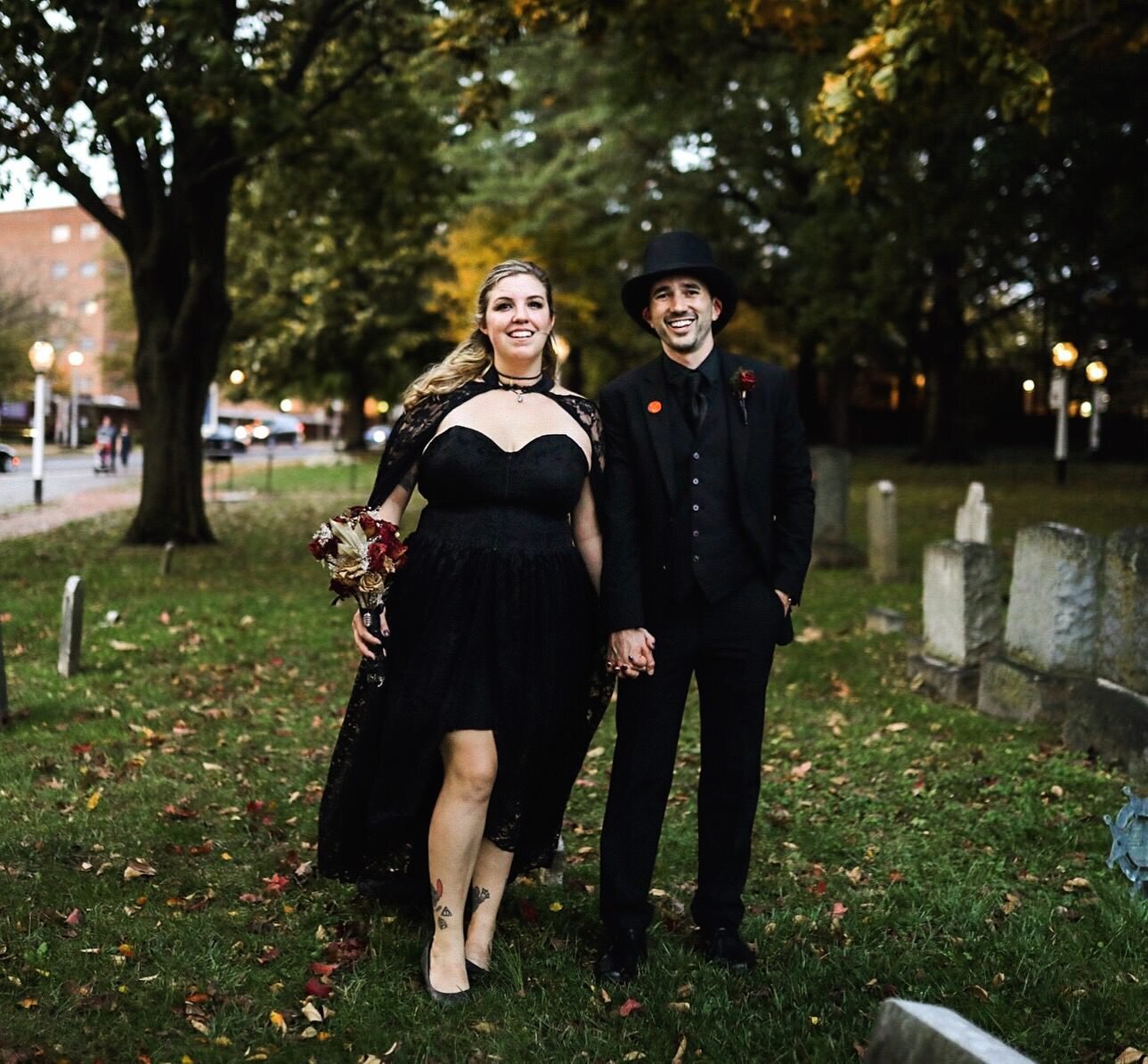 Bride and groom dressed in all black in a cemetery in Richmond VA Shawnee Custalow Queer Wedding Photography