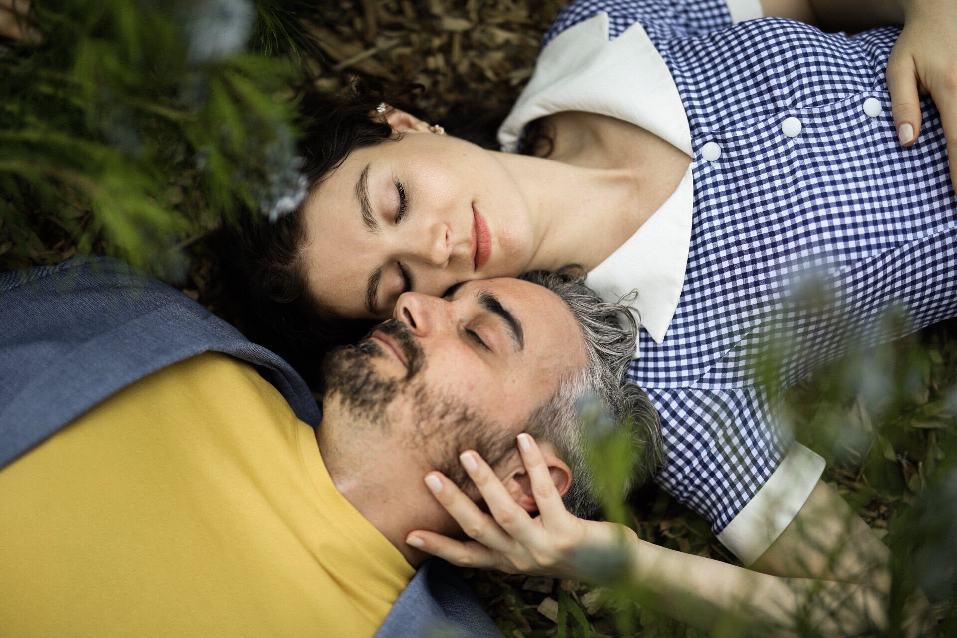 Couple laying with their heads together outside in Richmond VA Shawnee Custalow Queer Wedding Photographer