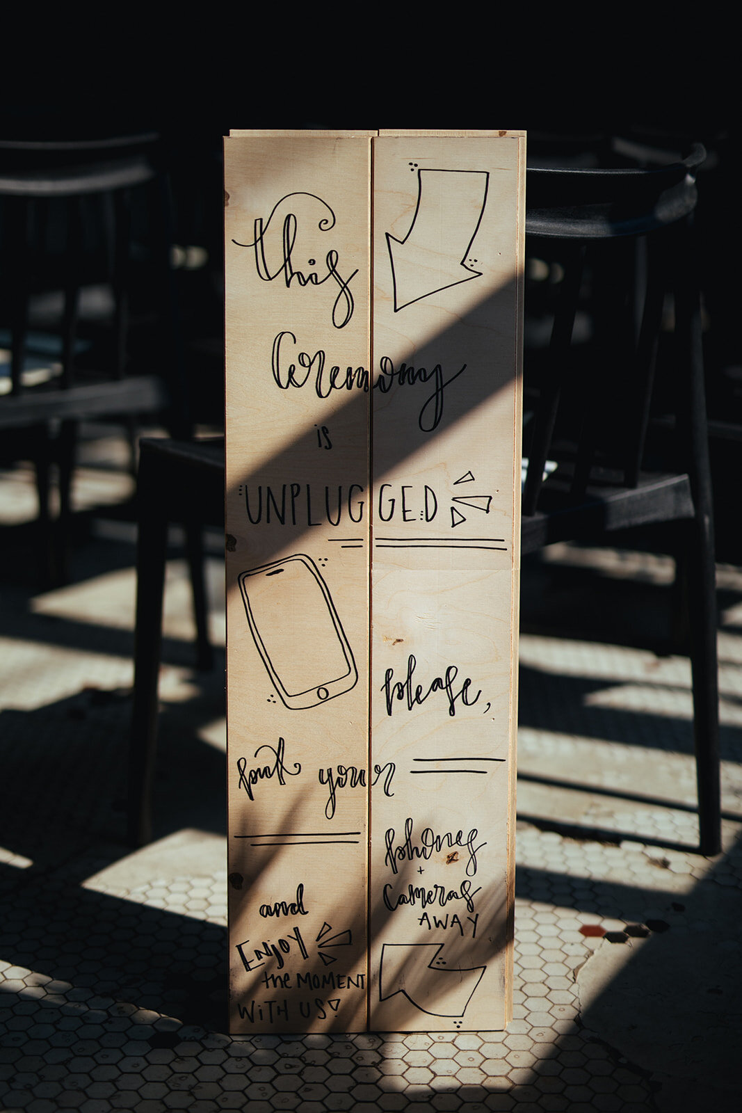 Hand drawn sign asking wedding guests to keep their phones off at Marlow Events in Brooklyn Shawnee Custalow Queer Wedding Photographer