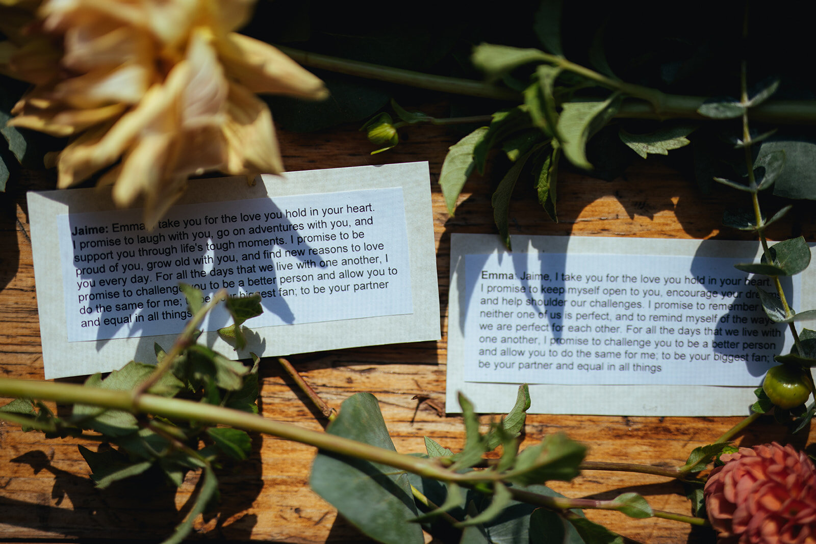 Vows typed and printed on two cards by flowers in Red Hook Brooklyn Shawnee Custalow Queer Wedding Photographer