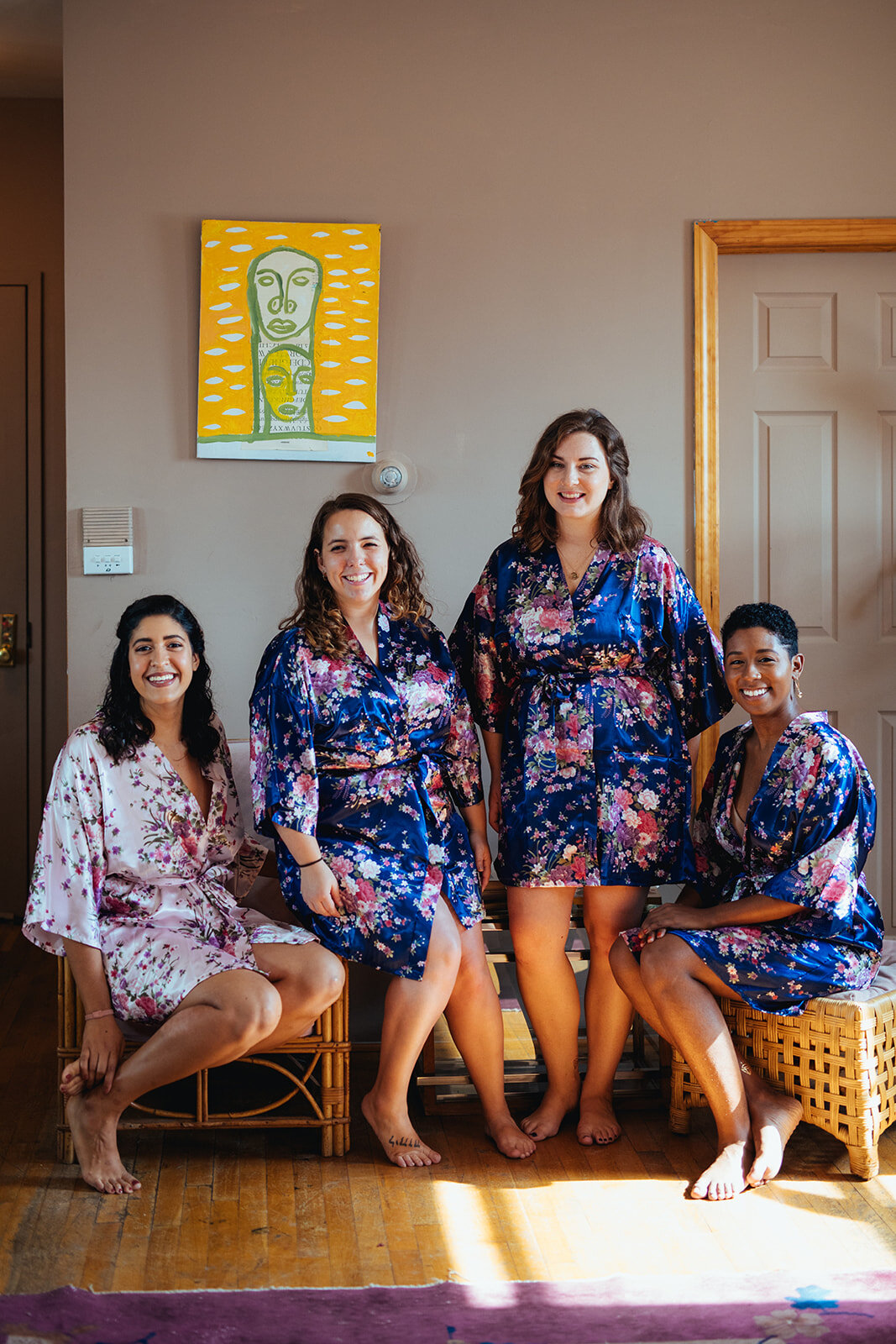 Three bridesmaids and bride in matching robes in Red Hook Brooklyn Shawnee Custalow Queer Wedding Photographer