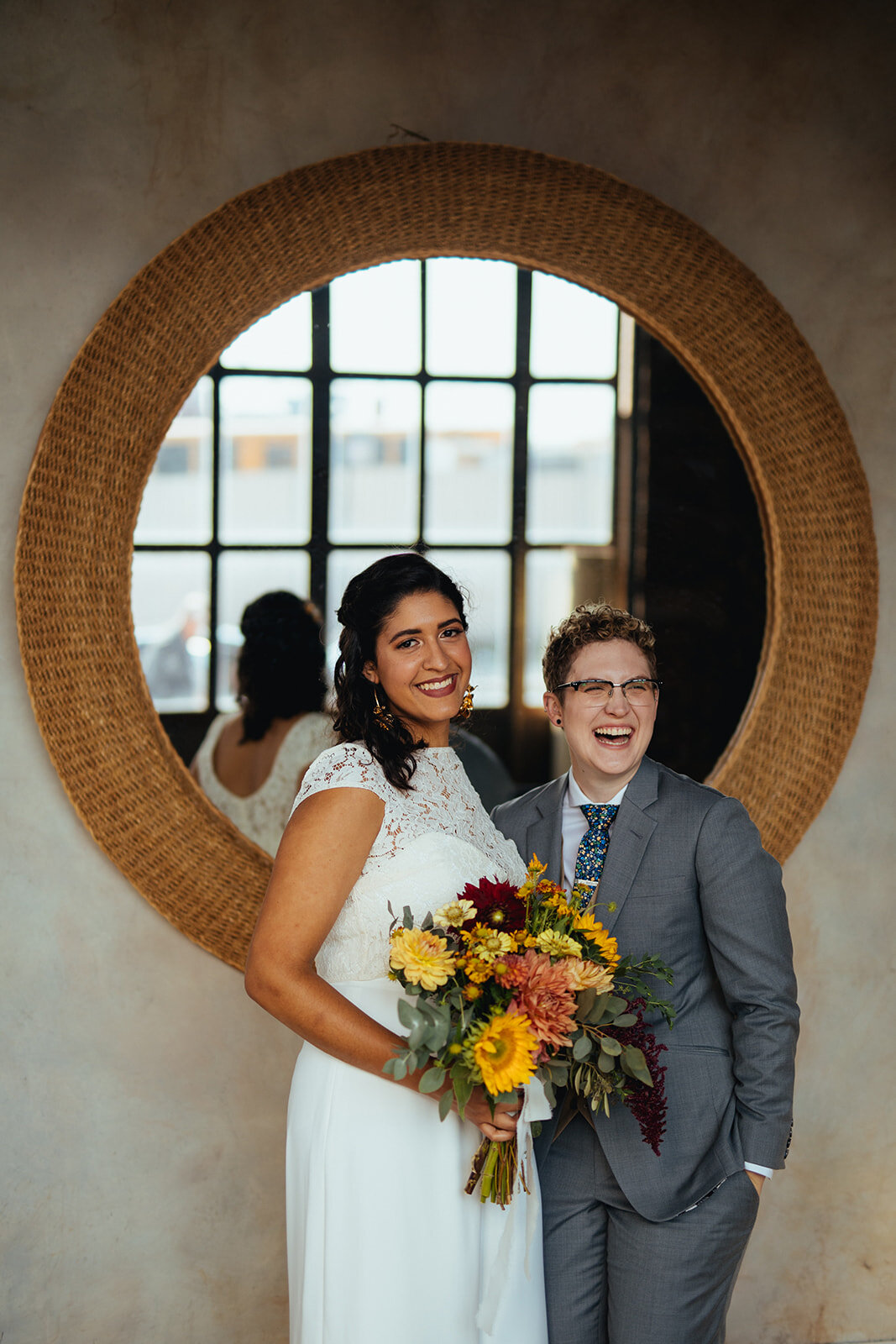 LGBTQ wedding couple posing before a mirror at Marlow Events in Red Hook Brooklyn Shawnee Custalow Queer Wedding Photographer