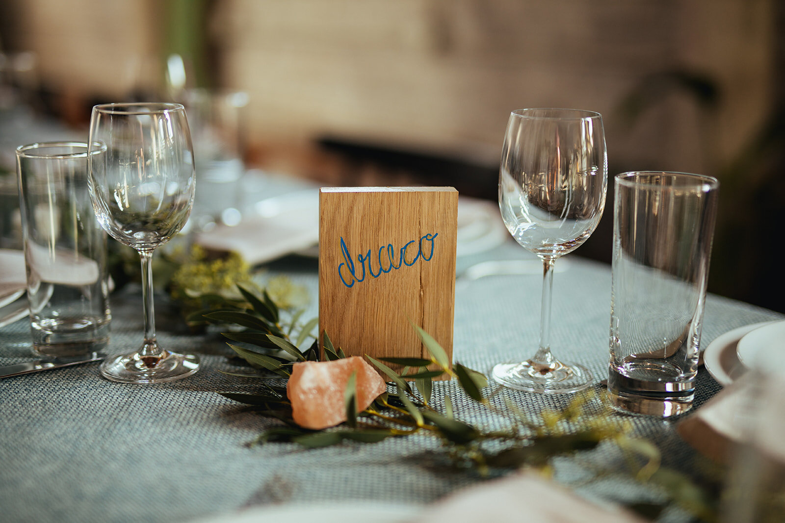 Table decor with a wooden name label by Marlow Events in Brooklyn Shawnee Custalow Queer Wedding Photographer