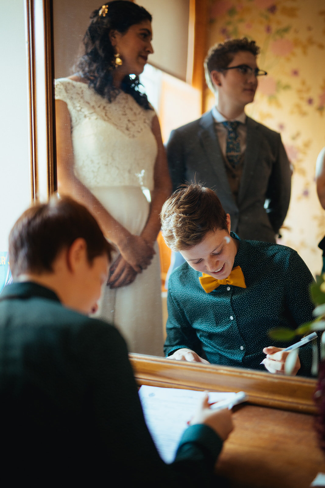 Witness signing marriage paperwork for lgbtq couple at Marlow Events in Brooklyn NY Shawnee Custalow Queer Wedding Photographer