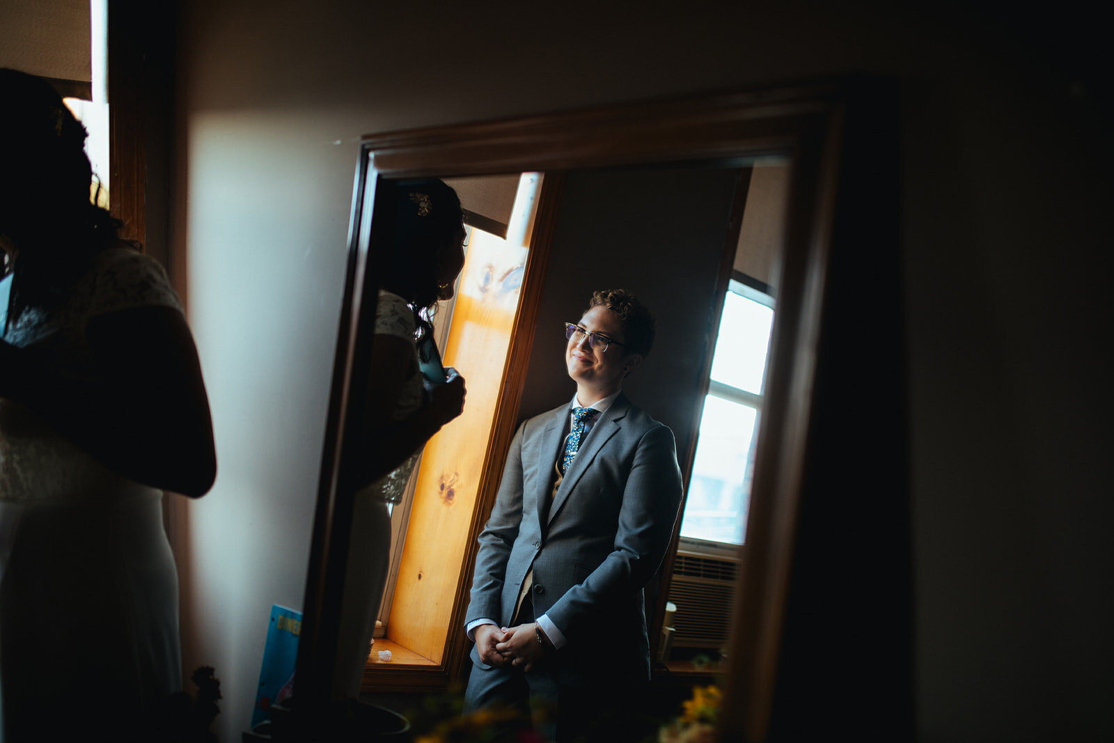 Portrait of LGBTQ wedding couple through a mirror in Red Hook Brooklyn Shawnee Custalow Queer Wedding Photographer