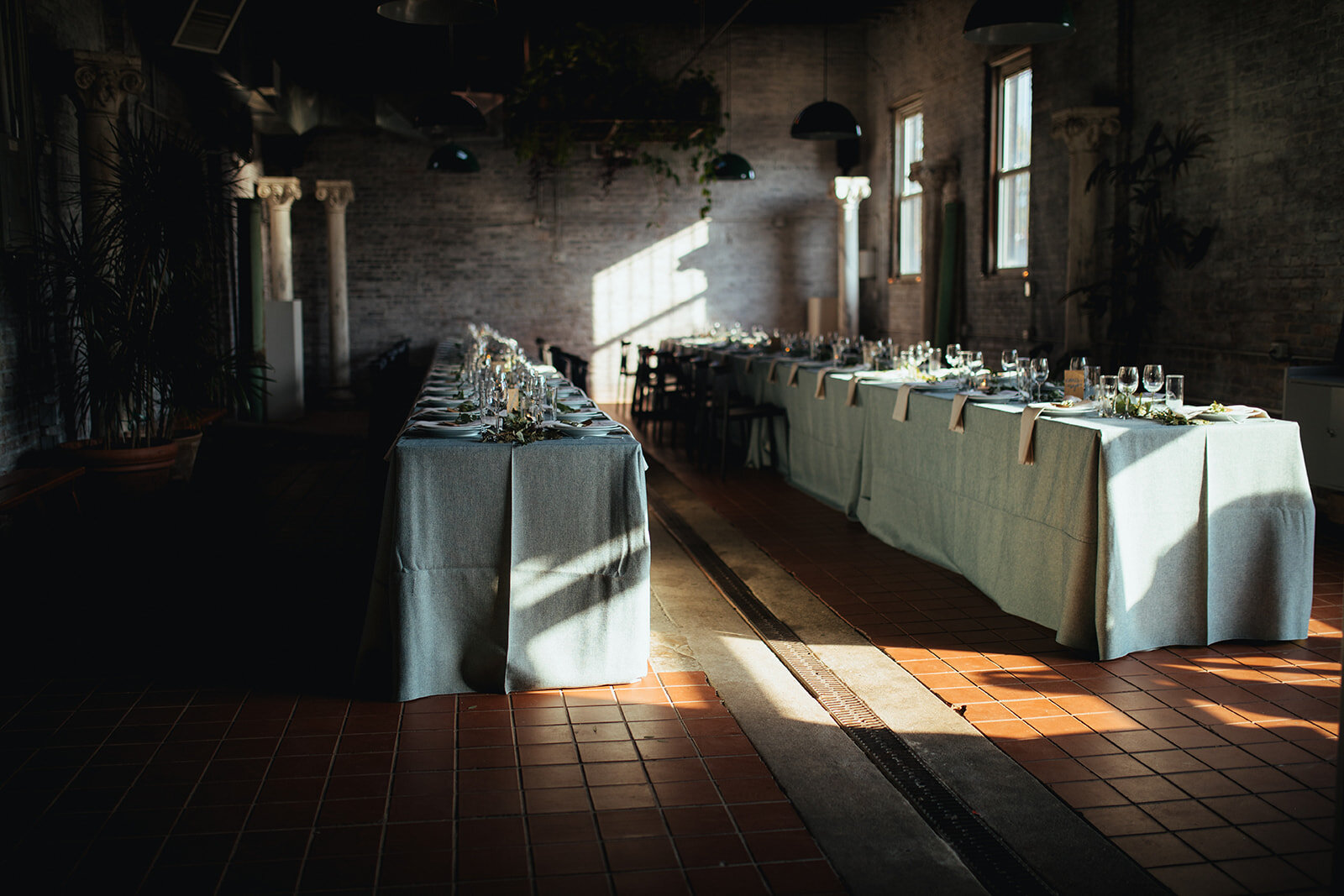 Two long tables set for wedding party at Marlow Events Red Hook Brooklyn Shawnee Custalow Queer Wedding Photographer