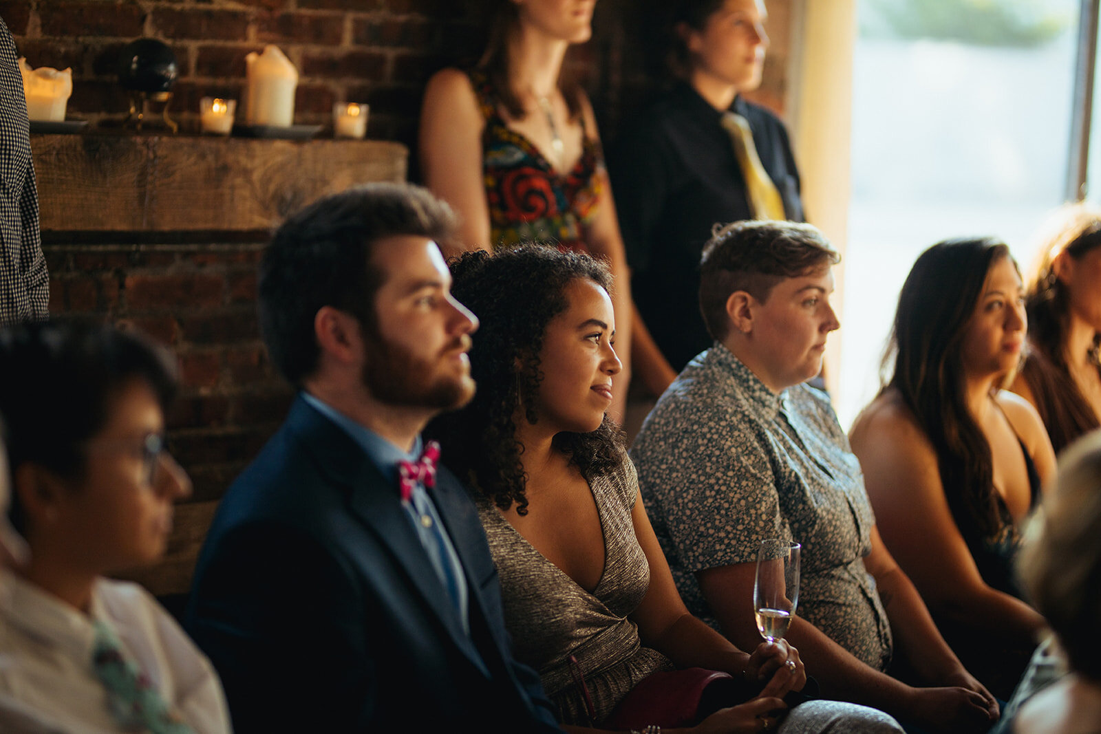 Wedding guests watching the ceremony at Marlow Events Red Hook Brooklyn Shawnee Custalow Queer Wedding Photographer