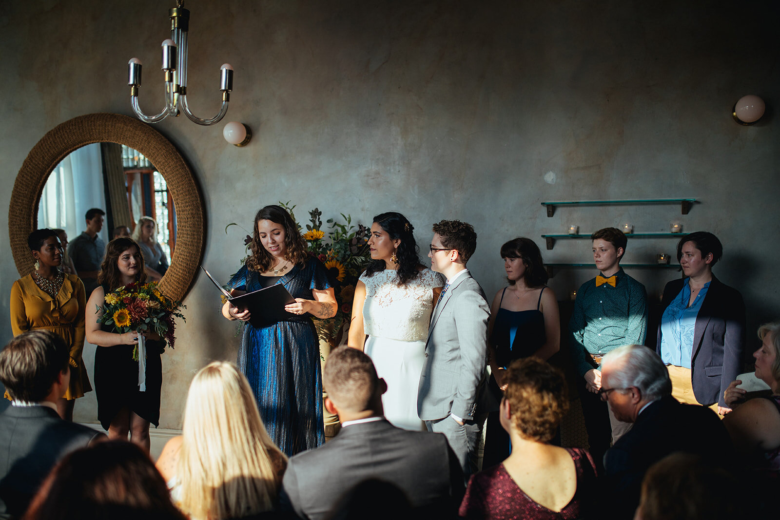 Officiant lgbtq couple and wedding party during the ceremony at Marlow Events Red Hook Brooklyn Shawnee Custalow Queer Wedding Photographer