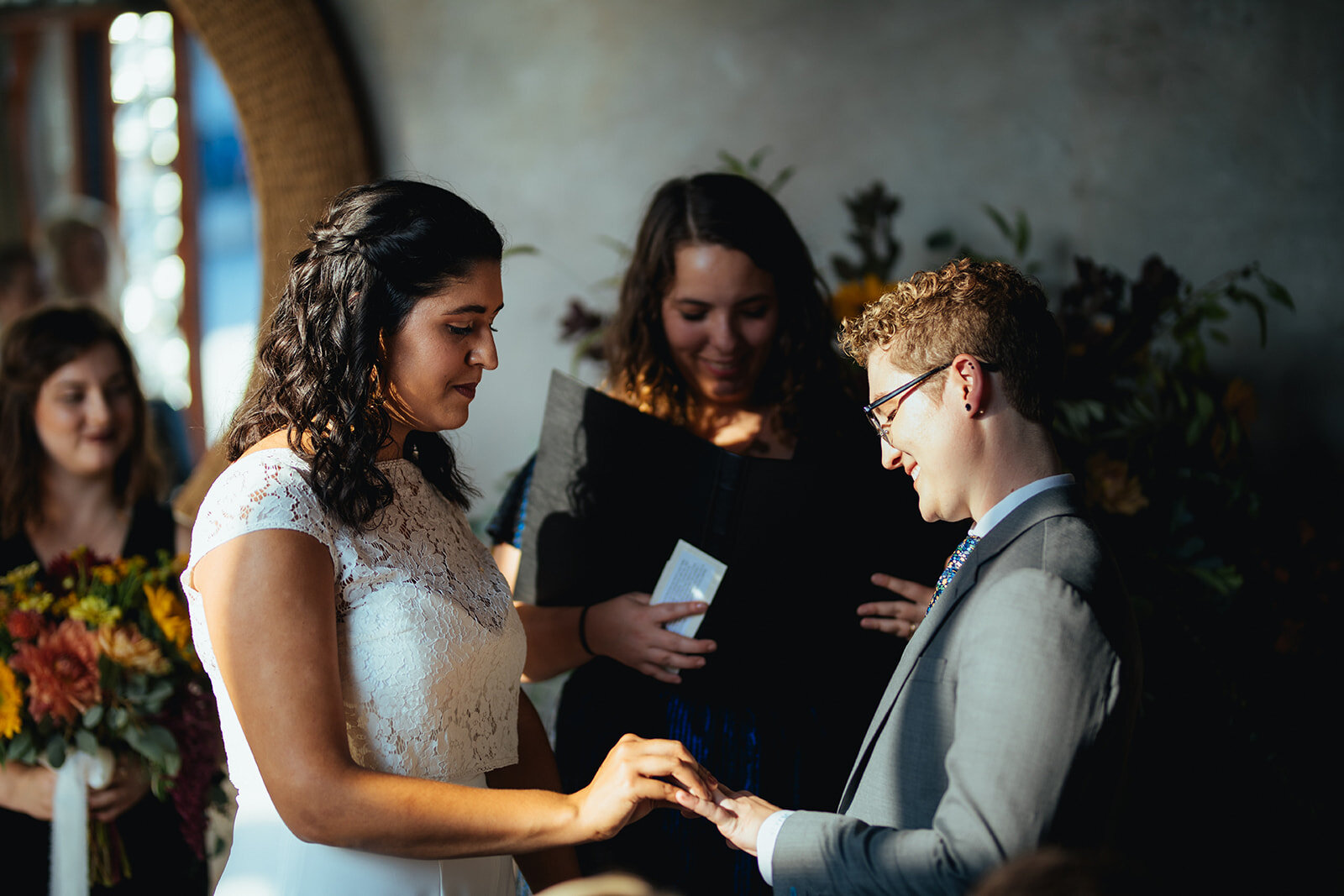 Queer couple exchanging wedding rings at Marlow Events Red Hook Brooklyn Shawnee Custalow Wedding Photographer