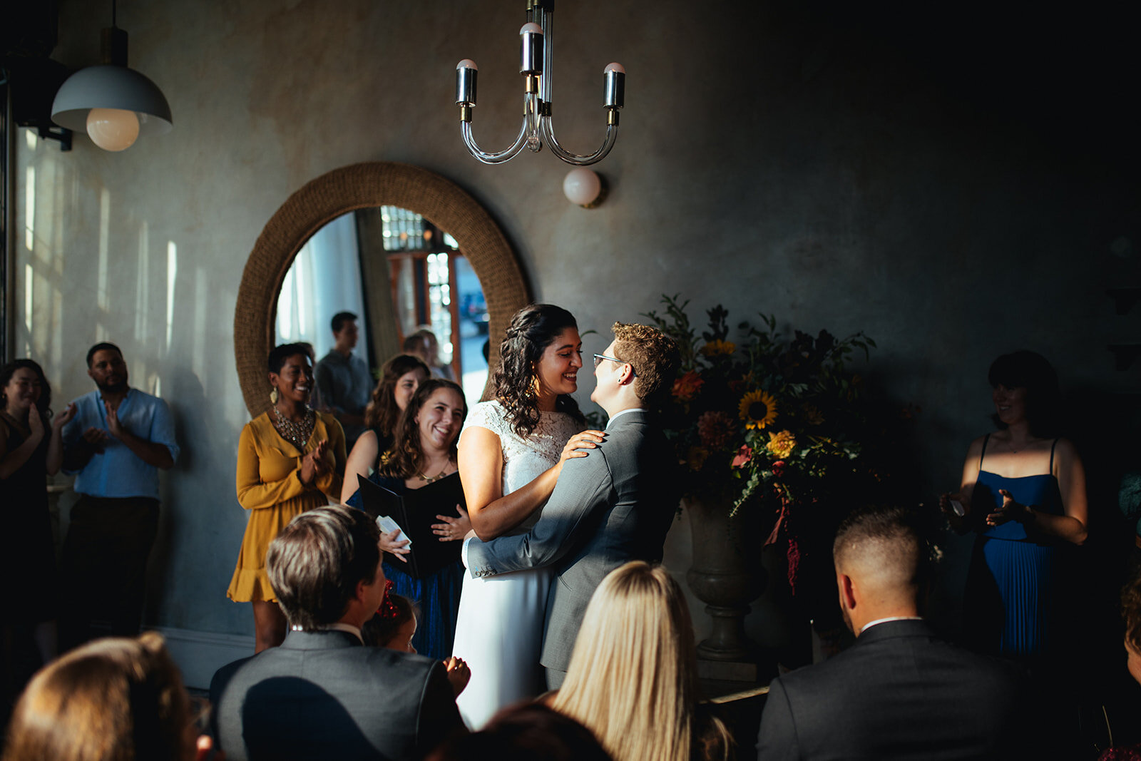 Newlywed LGBTQ couple holding each other during their ceremony Marlow Events Red Hook Brooklyn Shawnee Custalow Queer Wedding Photographer