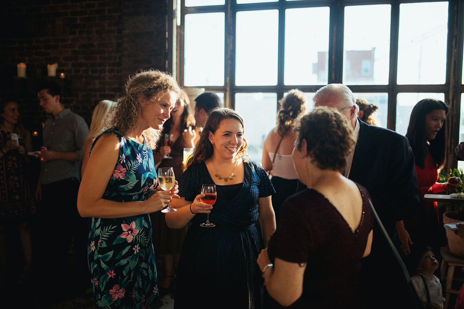 Wedding guests enjoying cocktails at Marlow Events Red Hook Brooklyn Shawnee Custalow Queer Wedding Photographer