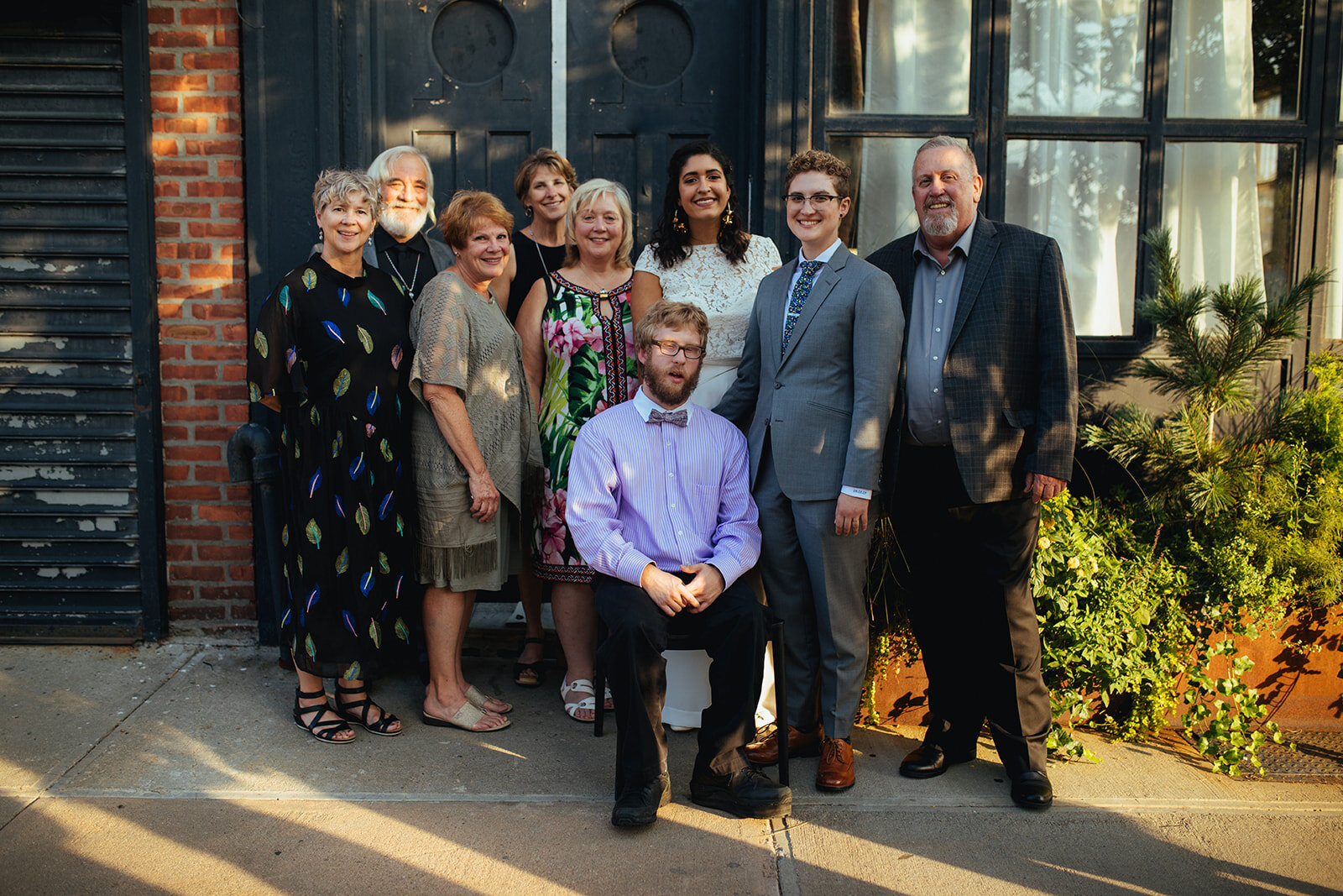 Newlyweds posing with family guests at Marlow Events Red Hook Brooklyn Shawnee Custalow Queer Wedding Photographer