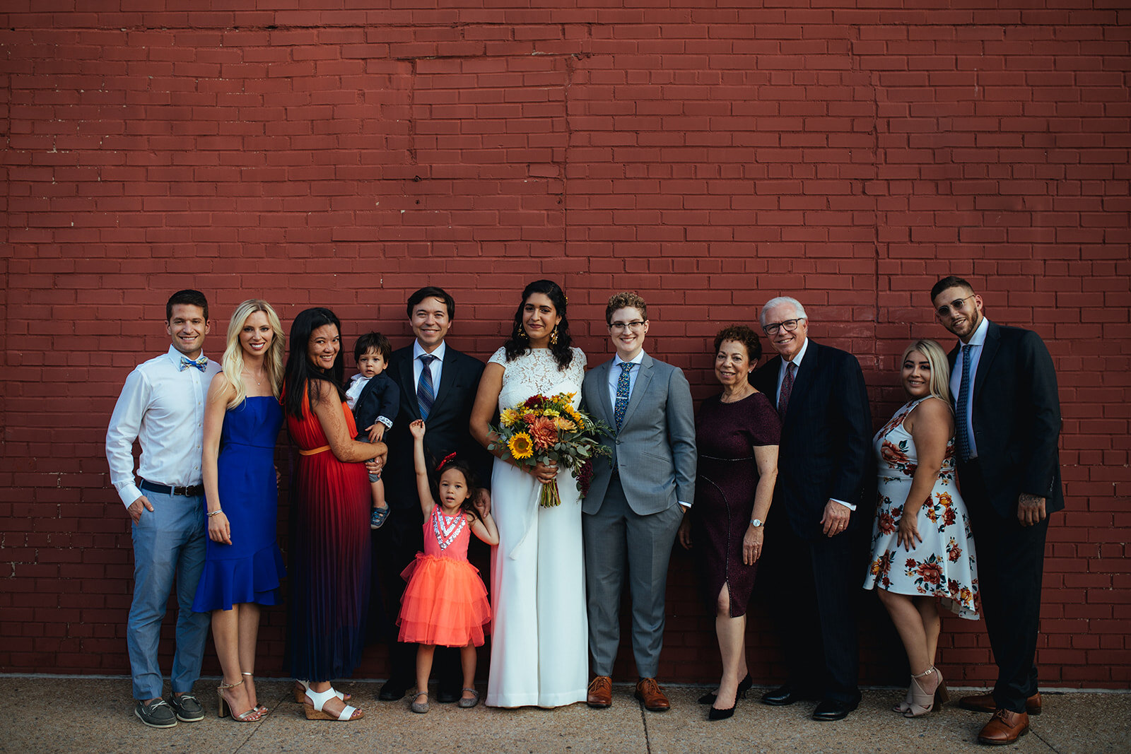 Newlyweds posing outside with family wedding guestsMarlow Events Red Hook Brooklyn Shawnee Custalow Queer Wedding Photographer