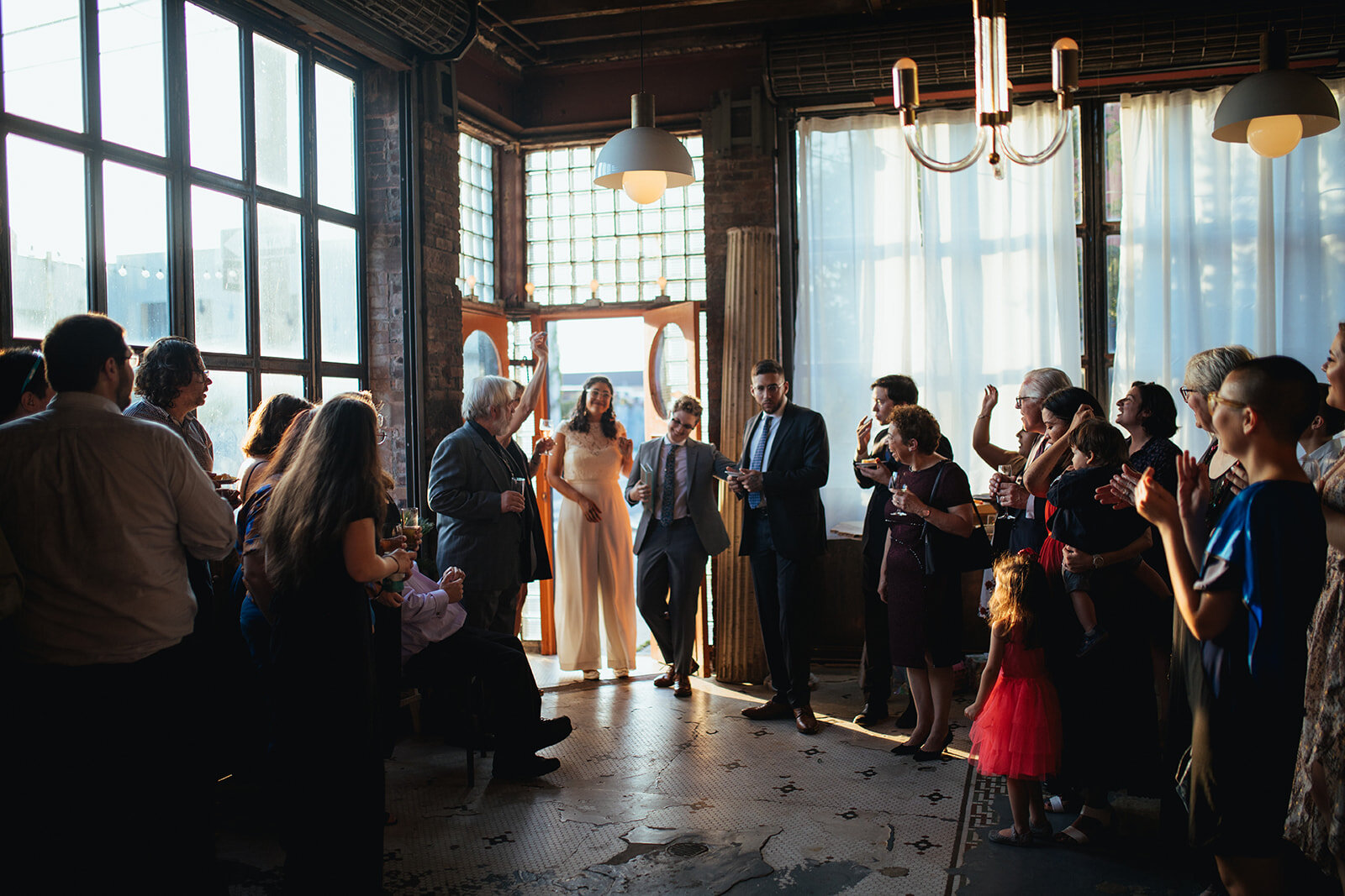 Newlywed rejoining their wedding reception at Marlow Events Red Hook Brooklyn Shawnee Custalow Queer Wedding Photographer