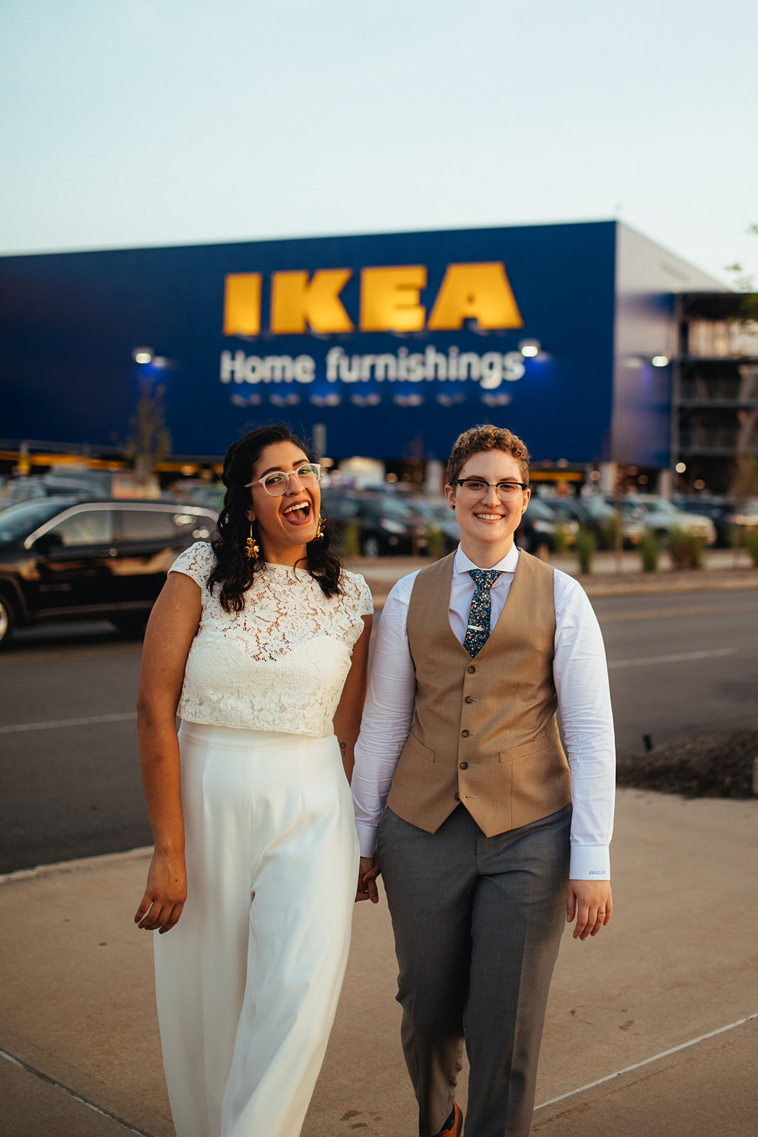 Newlywed couple posing together by Ikea in Red Hook Brooklyn Shawnee Custalow Queer Wedding Photographer