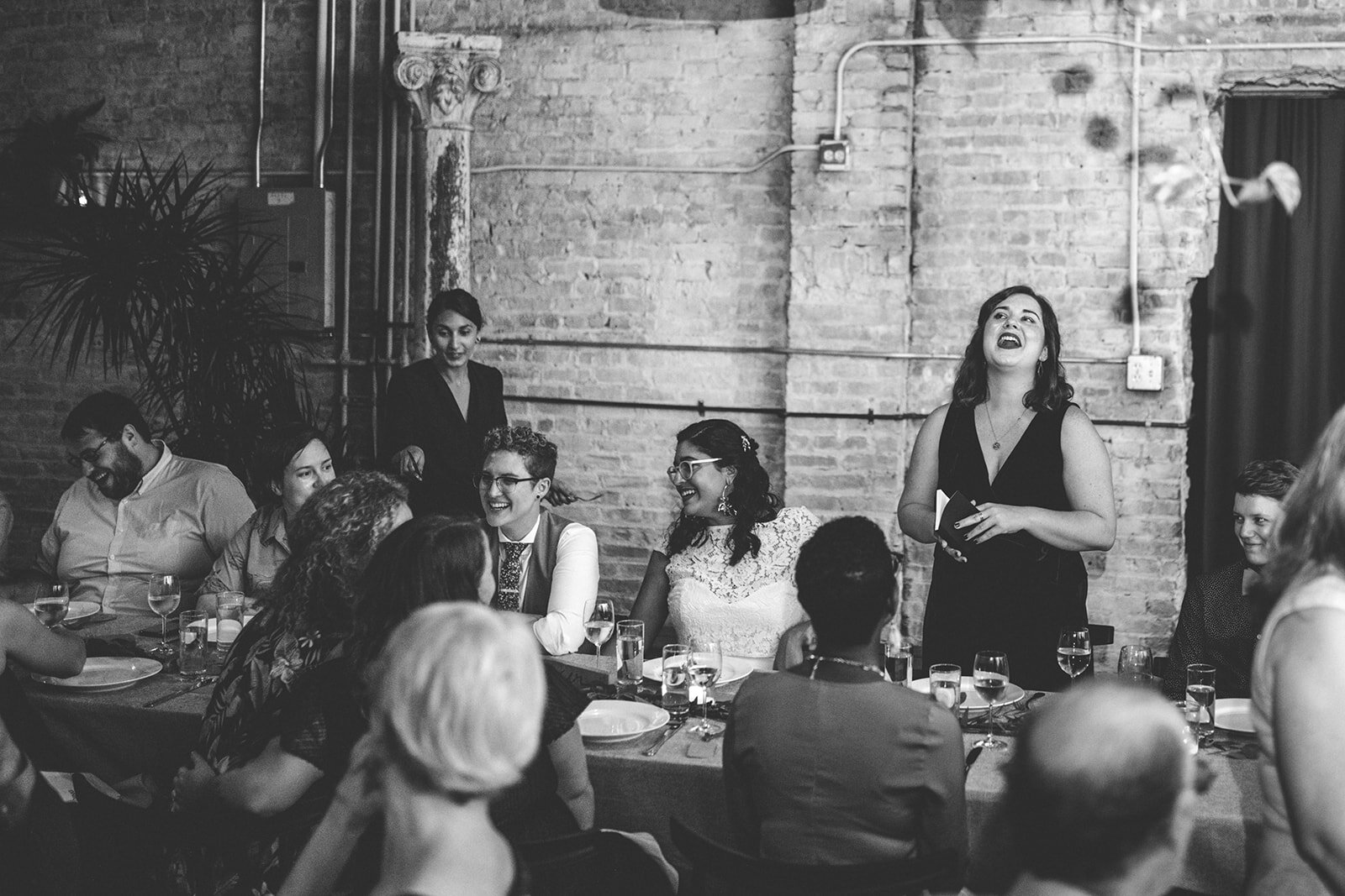 Bridesmaid giving a speech at a wedding reception dinner at Marlow Events Brooklyn Shawnee Custalow Queer Wedding Photographer