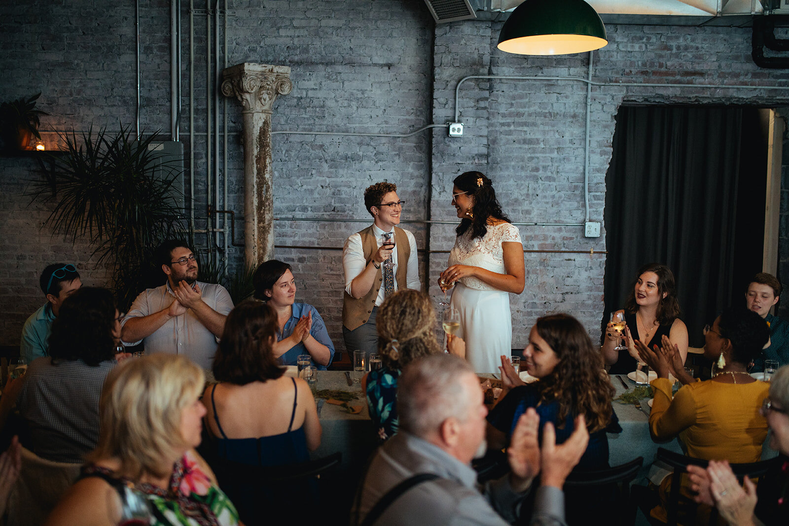 Newlywed couple giving a speech at their reception at Marlow Events Red Hook Brooklyn Shawnee Custalow Queer Wedding Photographer