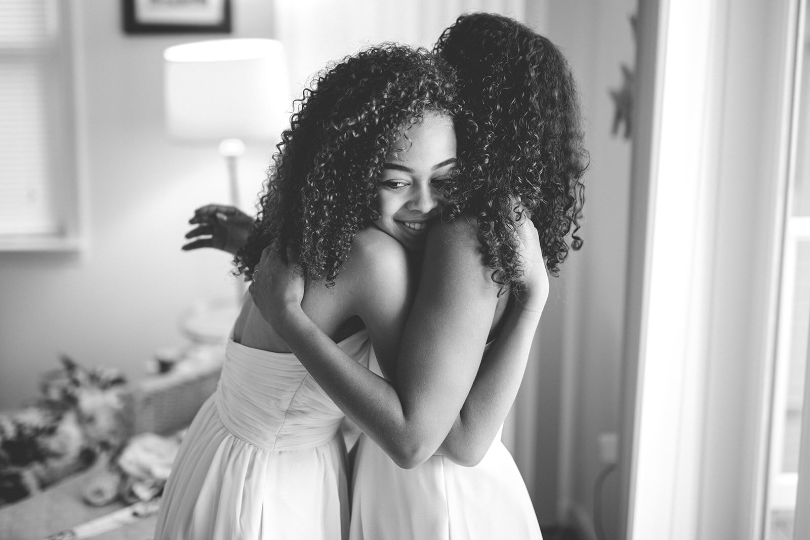 Two bridesmaids embracing in Annapolis MD Shawnee Custalow Queer Wedding Photographer