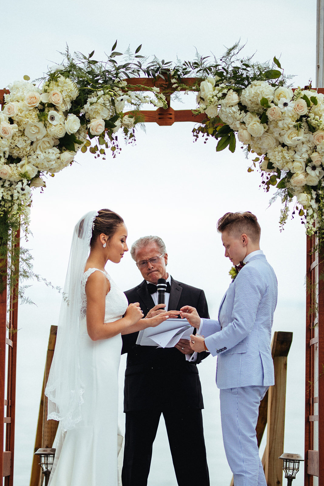 LGBTQ couple exchanging rings in Annapolis MD Shawnee Custalow Wedding Photographer