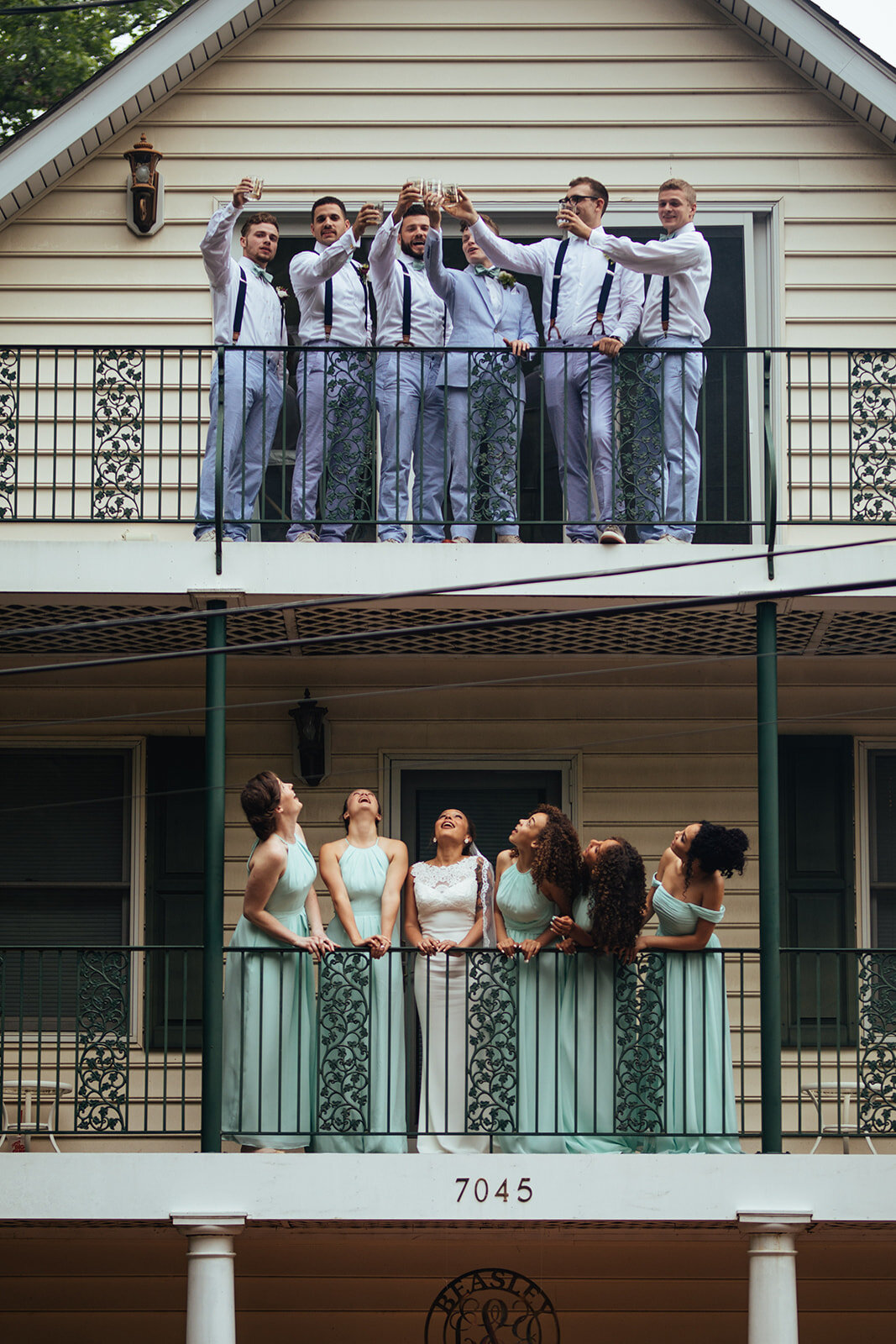 Newlyweds and honor attendants on two balconies in Annapolis MD Shawnee Custalow Photography